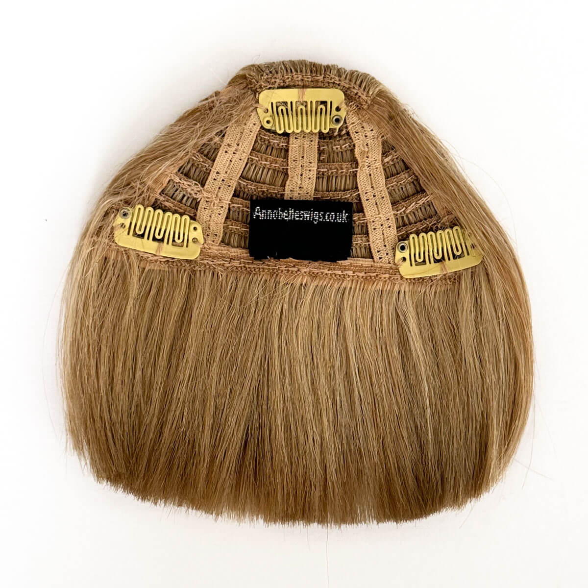 Blonde hair extension with gold clips on a white background. Clip-in fringe hairpiece/clip-in micro-bangs, thick, straight retro rockabilly style: Ida blonde 613T24