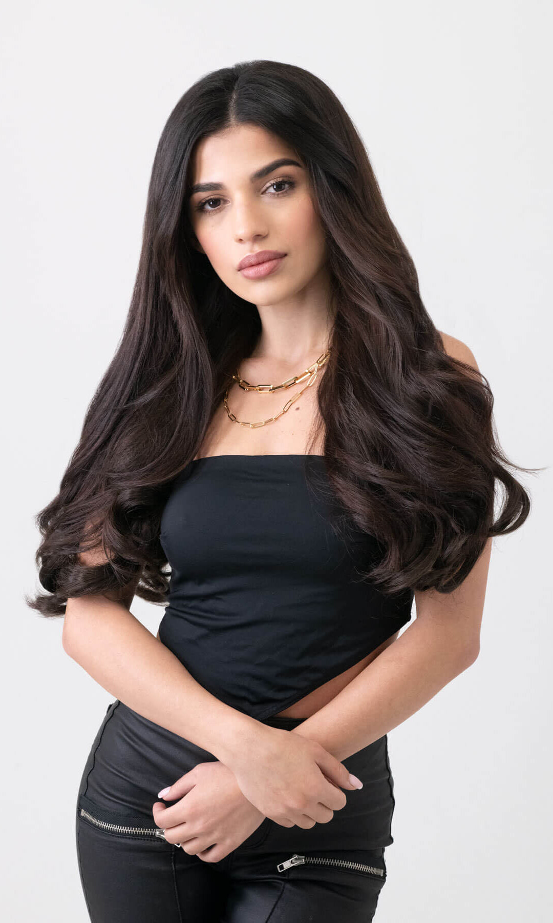 Woman with long dark hair wearing a black top against a white background. synthetic hair extension set, 5 piece, 18 inches long, 260g dark brown 4