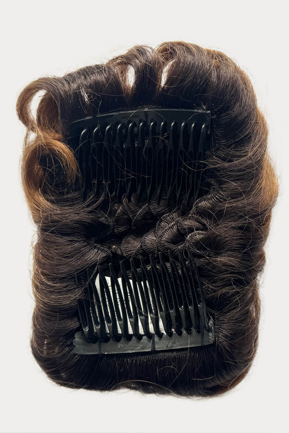 Brown hair extension with black clip on a white background. Hair poodle clip-in hairpiece bun vintage style 1950s: Lucille 4TN27