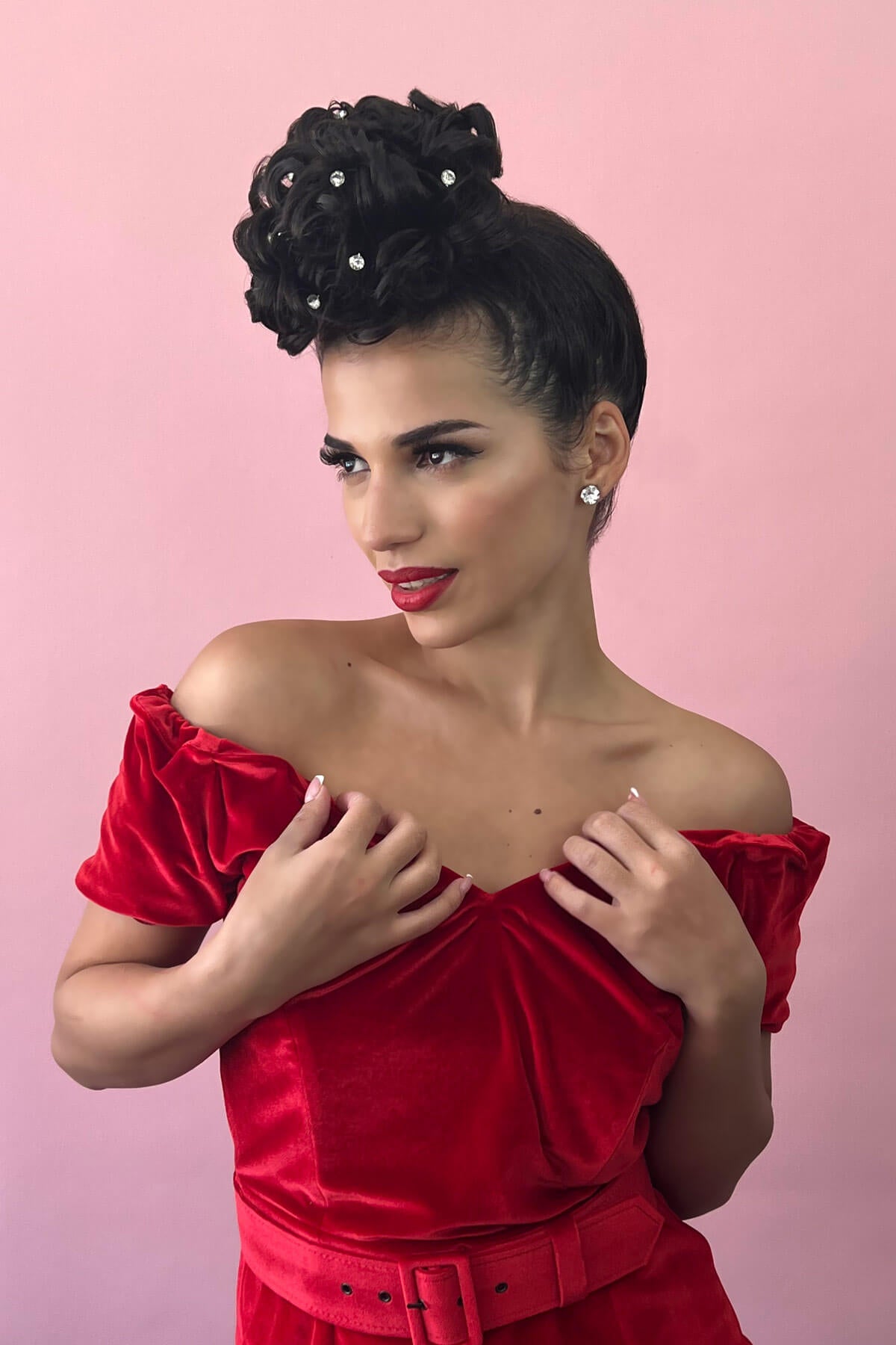 Woman in a red off-shoulder dress with a pink background. Hair poodle clip-in hairpiece bun vintage style 1950s: Lucille chestnut brown 8