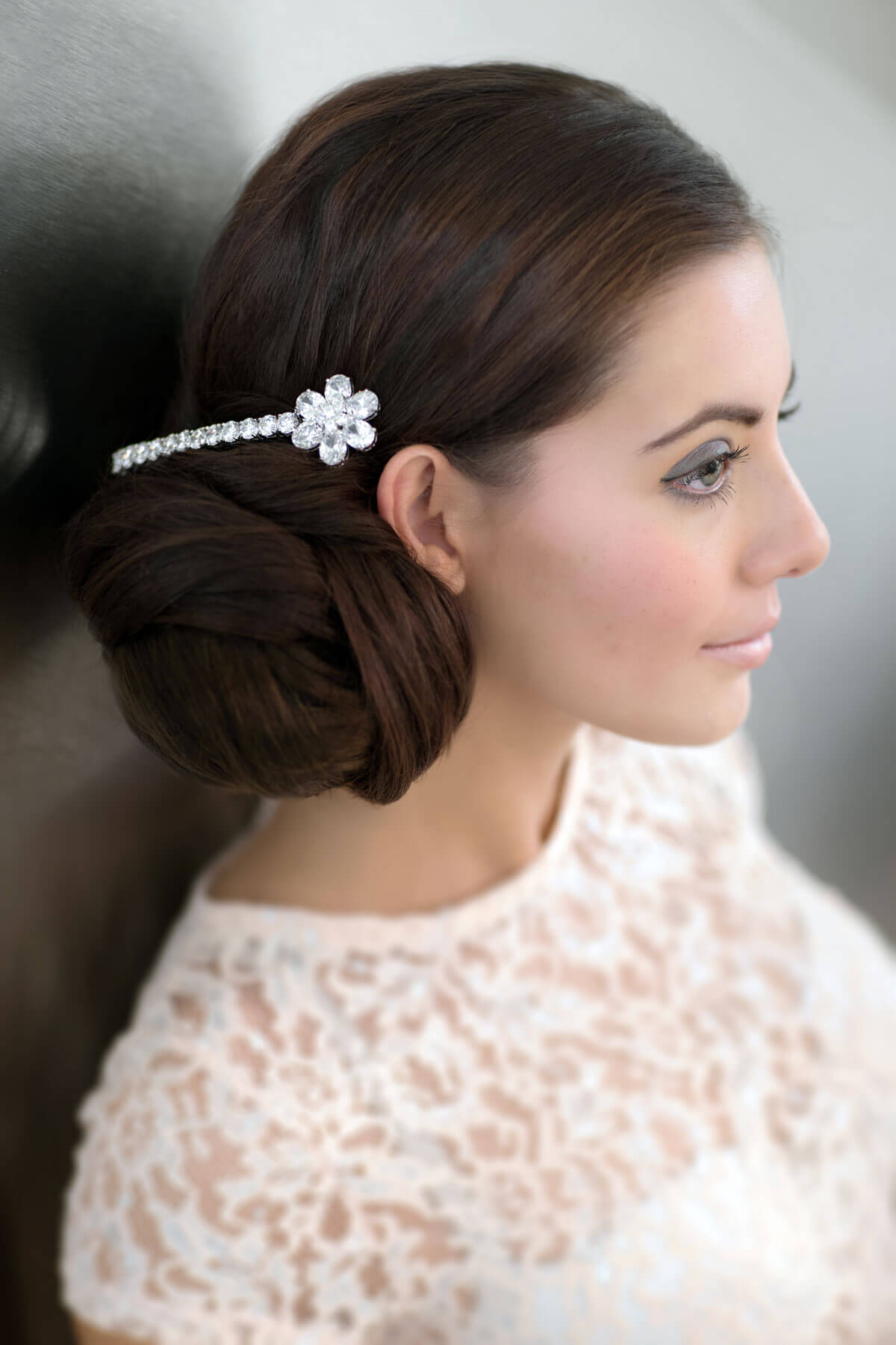 Woman with braided hair adorned with a decorative hairpin against a neutral background. Extension hairpiece, long, versatile, Flexihair: Cristina chestnut brown 8