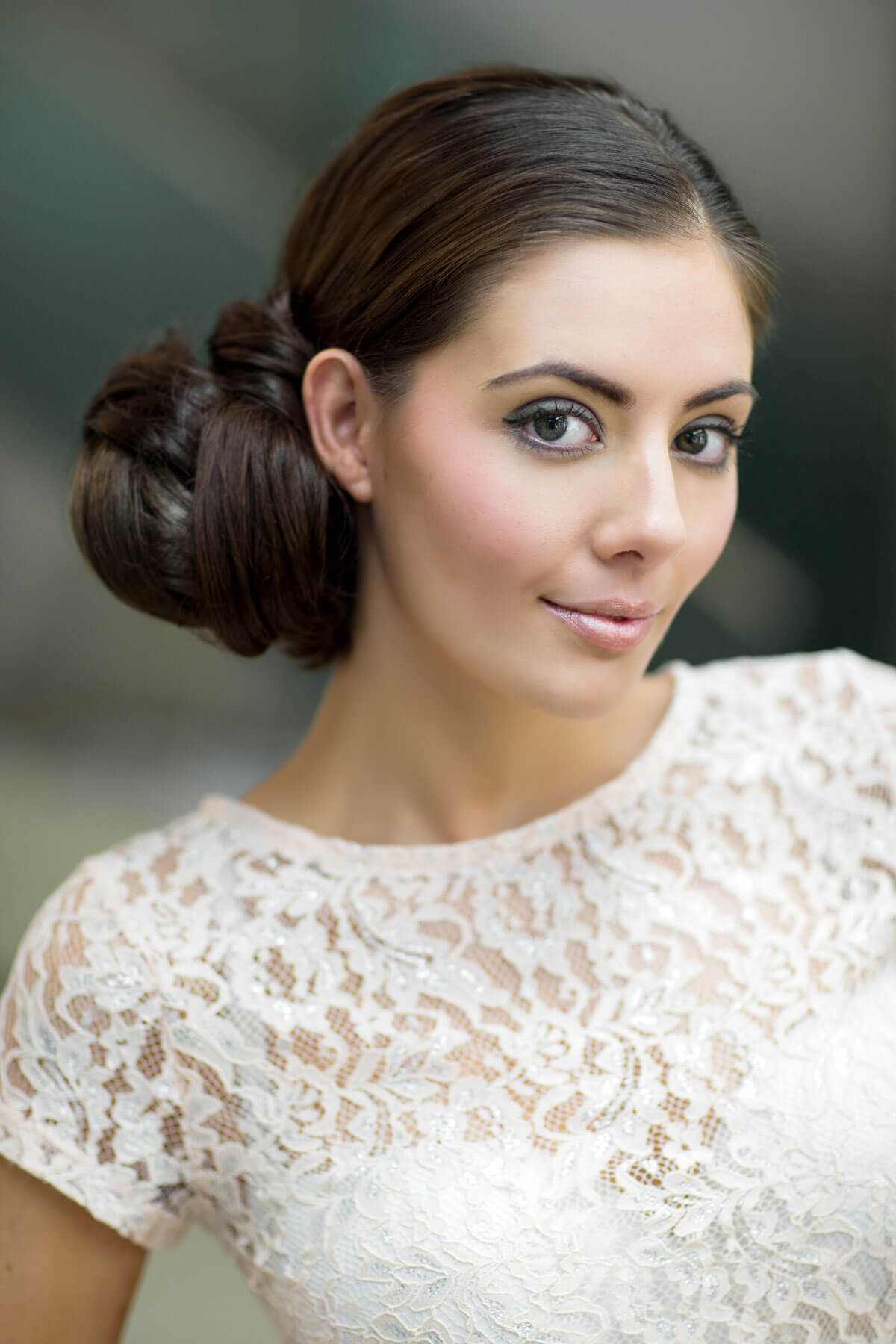 Woman with styled hair wearing a white lace top against a blurred background. Extension hairpiece, long, versatile, Flexihair: Cristina chestnut brown 8
