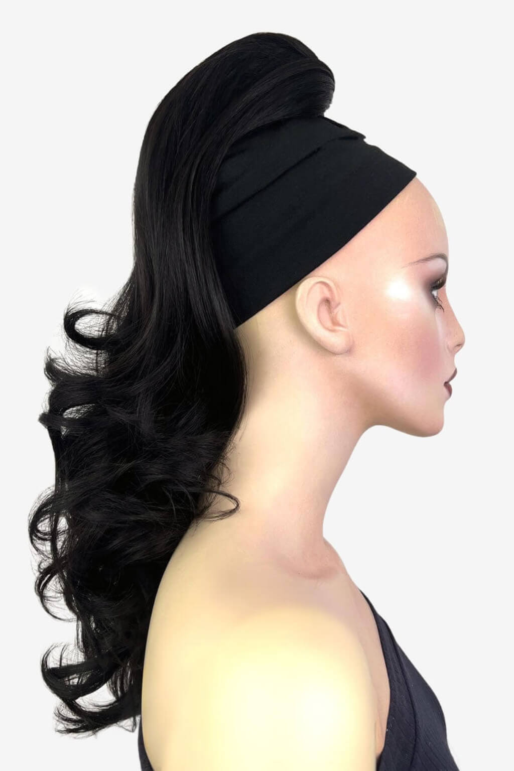 Woman with styled hair and headband on a white background. Wavy ponytail hairpiece extension: Casey