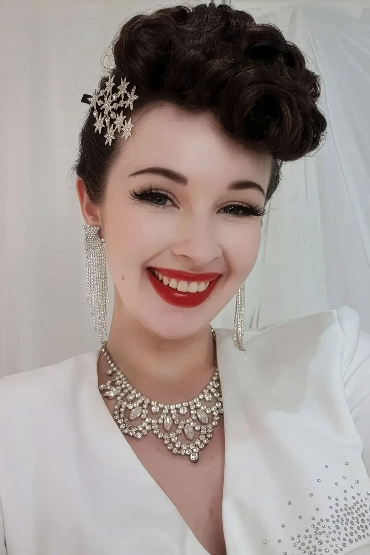 Woman in a bridal outfit with jewelry and makeup, smiling. Hair poodle clip-in hairpiece bun vintage style 1950s: Lucille chestnut brown 8
