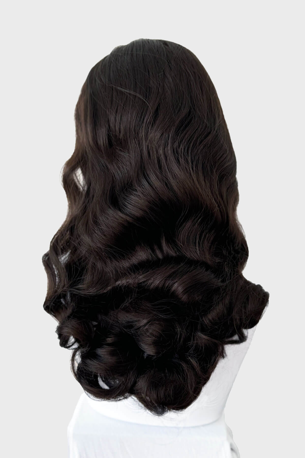 Dark brown wig on a mannequin head against a white background. 1950s style half wig hairpiece with beautiful waves: Morgana dark brown 6