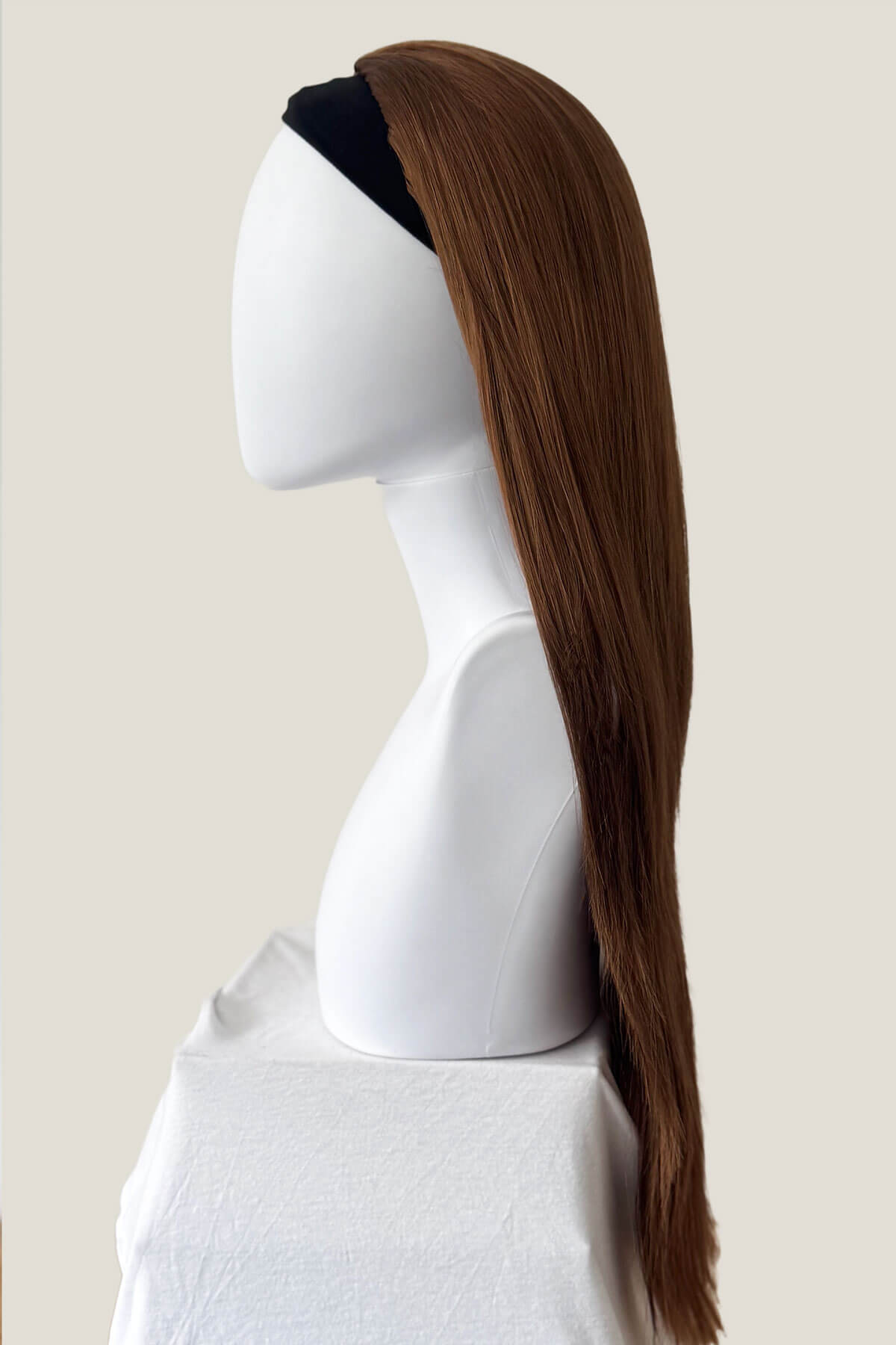 Brown ponytail wig on a mannequin head against a plain background. Straight brown half wig hairpiece extension, long: Faye Auburn brown 30