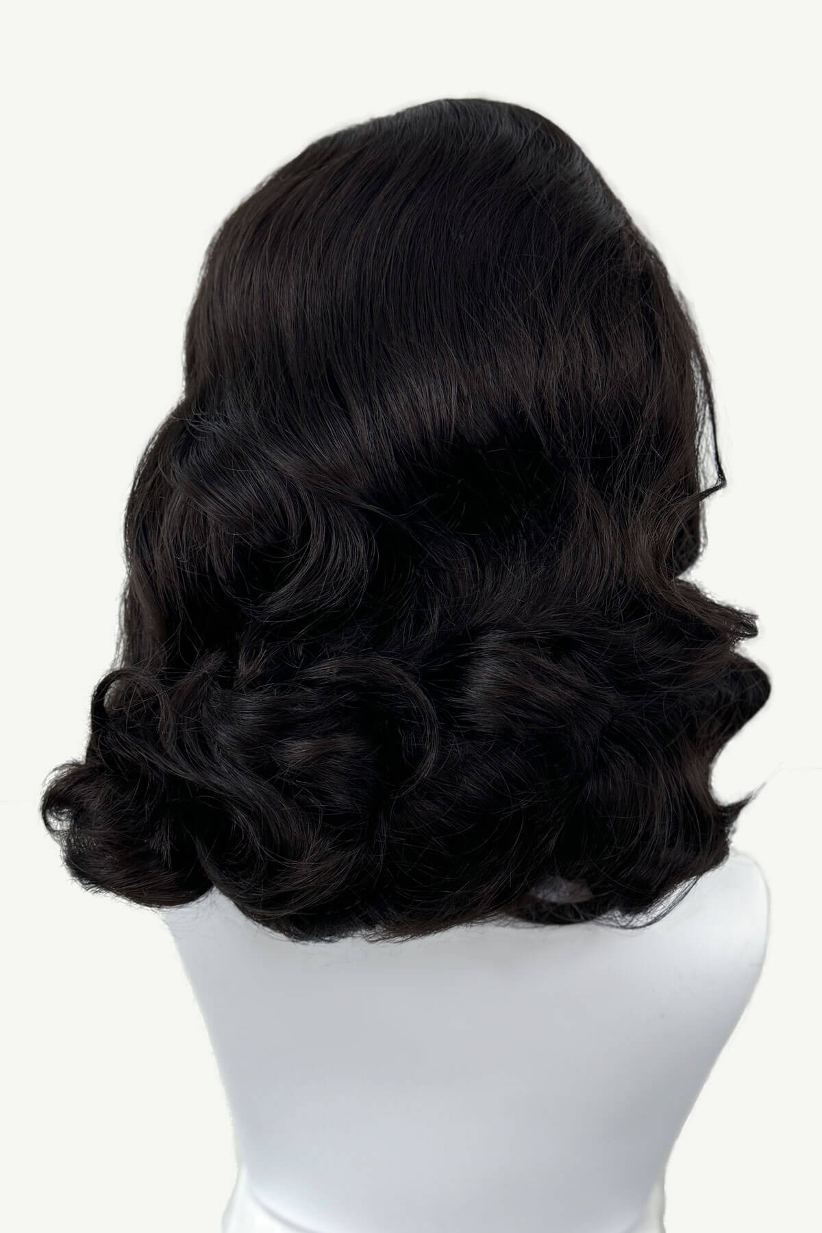 Dark brown wig on a mannequin head against a white background viewed from the back. 1950s style shoulder length half wig hairpiece with beautiful vintage waves: Onyx dark brown 4