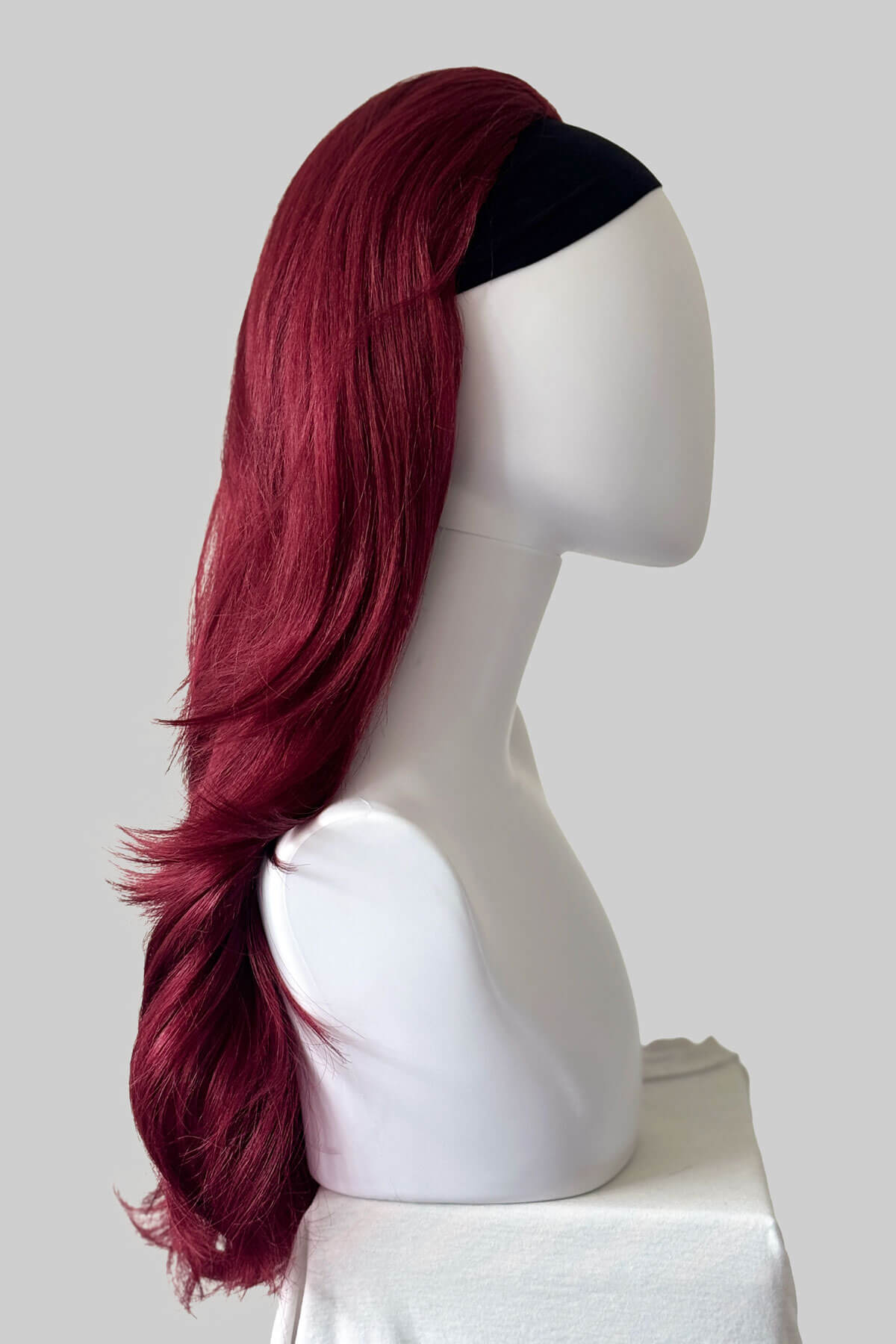 A long, wavy half wig in deep burgundy red displayed on a white mannequin head against a light grey background. Claudia - Volume Boosting Long Gentle Bouncy Layered Half wig dark cherry red 39