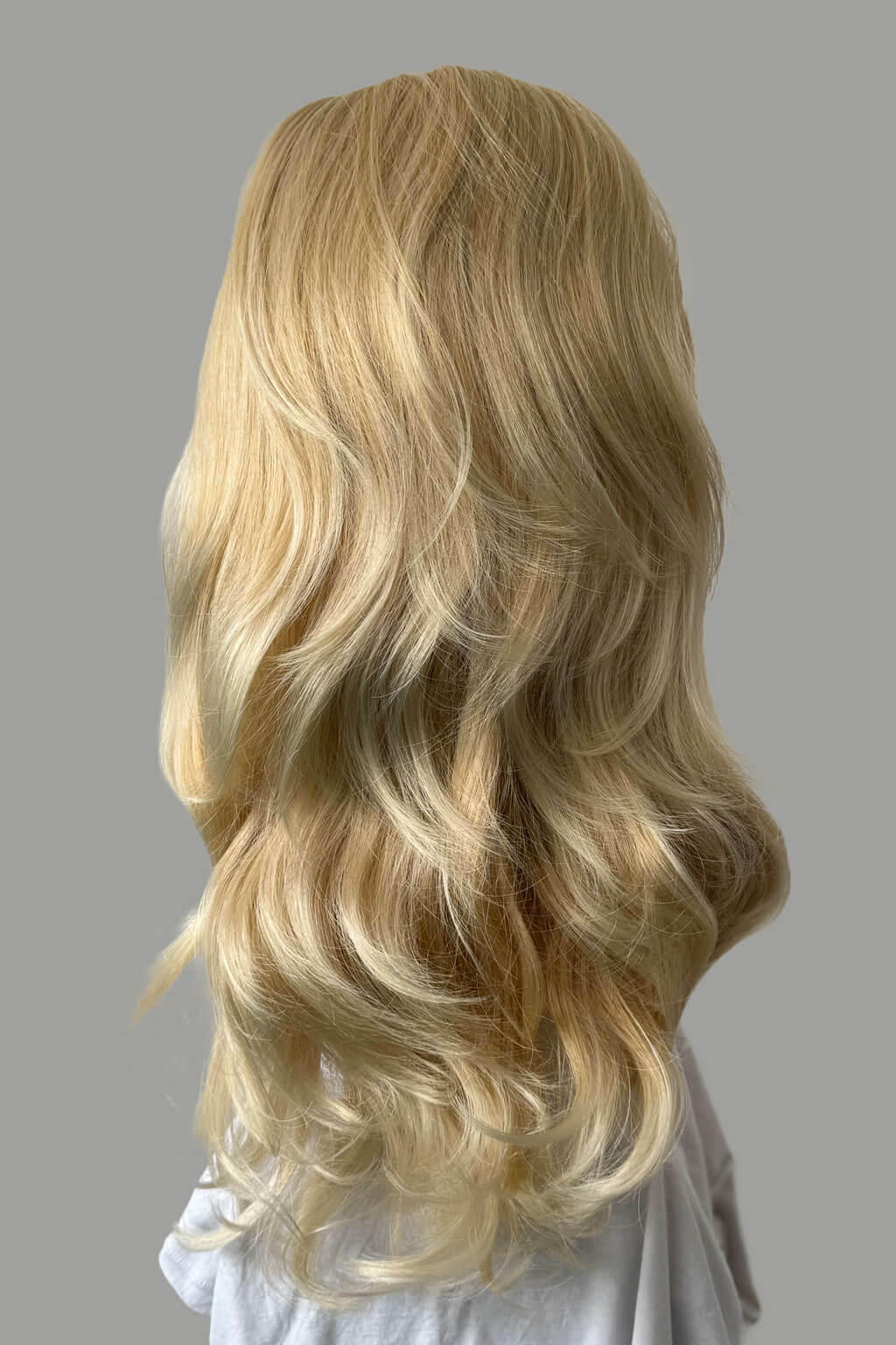 Blonde wig with wavy hair on a gray background - High crown long, layered half wig and volume ring: Helena light ash blonde 24BT613
