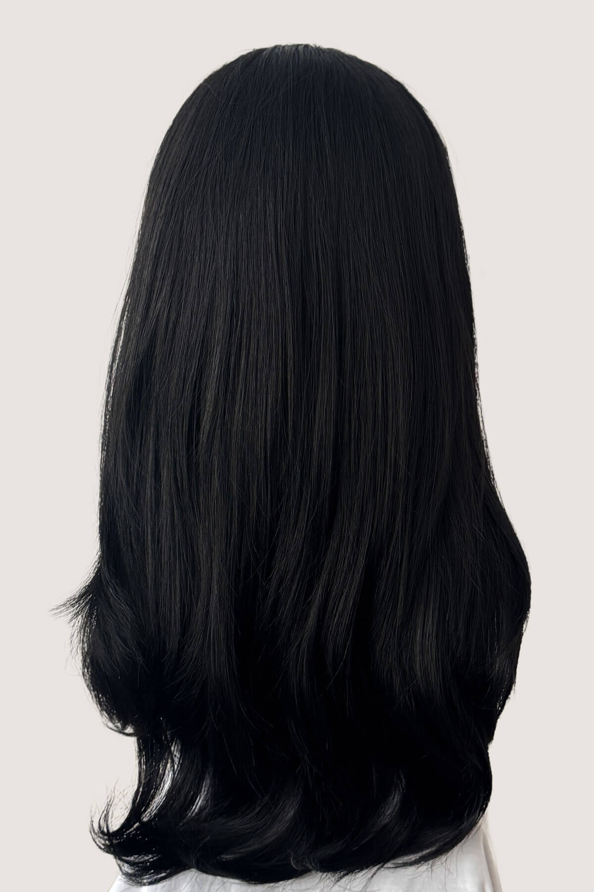 Black wig on a white background. Straight black hairpiece (3/4 wig), long and layered: Raven