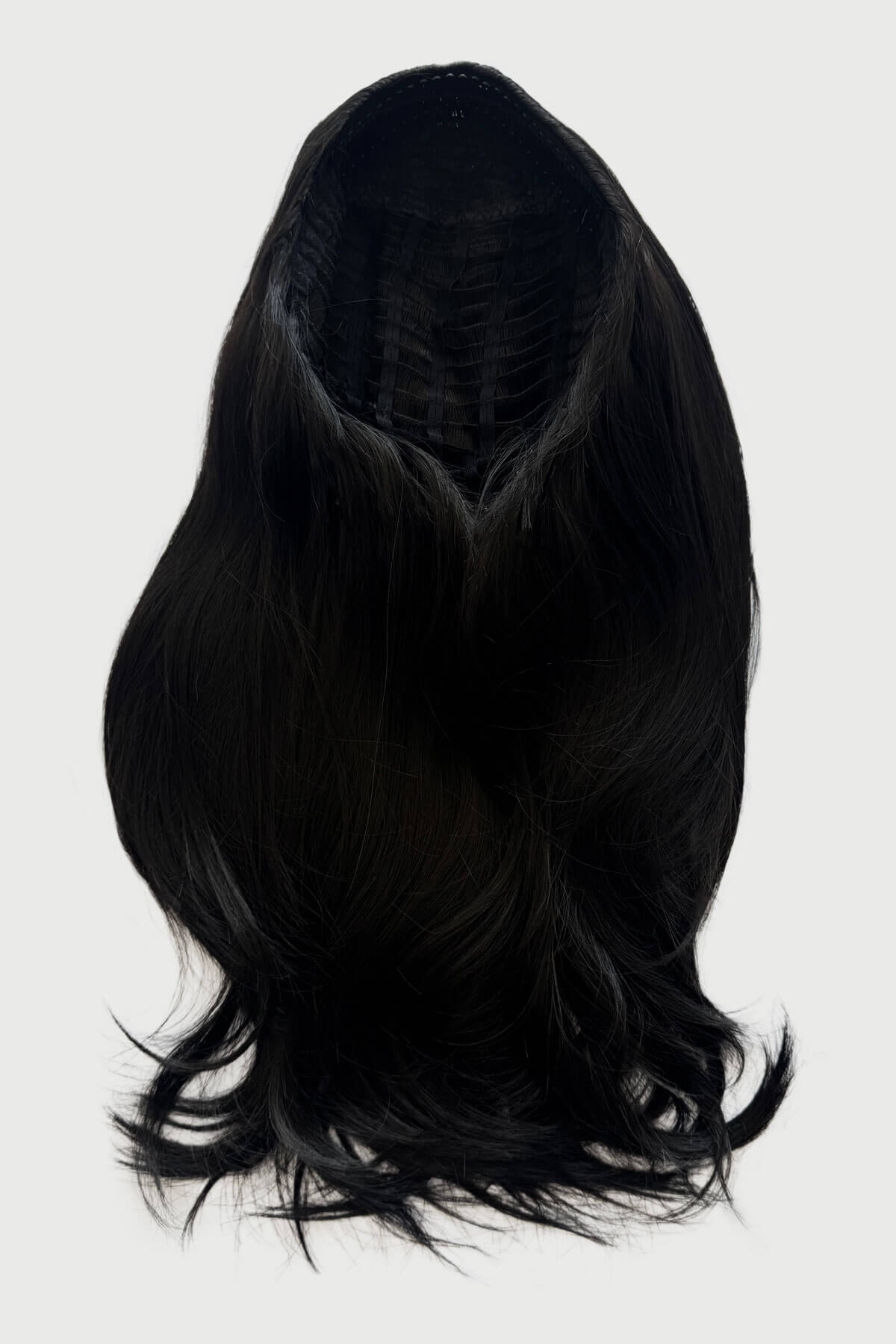 Black wig on a white background. Straight black hairpiece (3/4 wig), long and layered: Raven