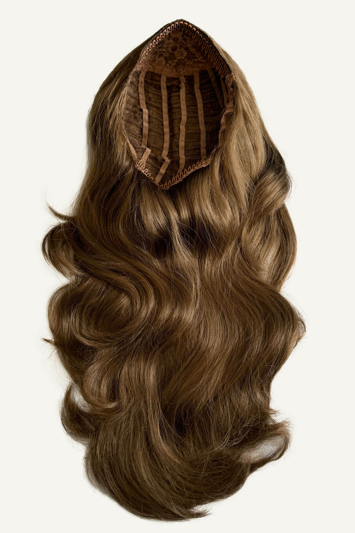 Brown hair extension with a clip on a white background. Brown half wig hairpiece (3/4 wig), layered, wavy: Simone light brown 12