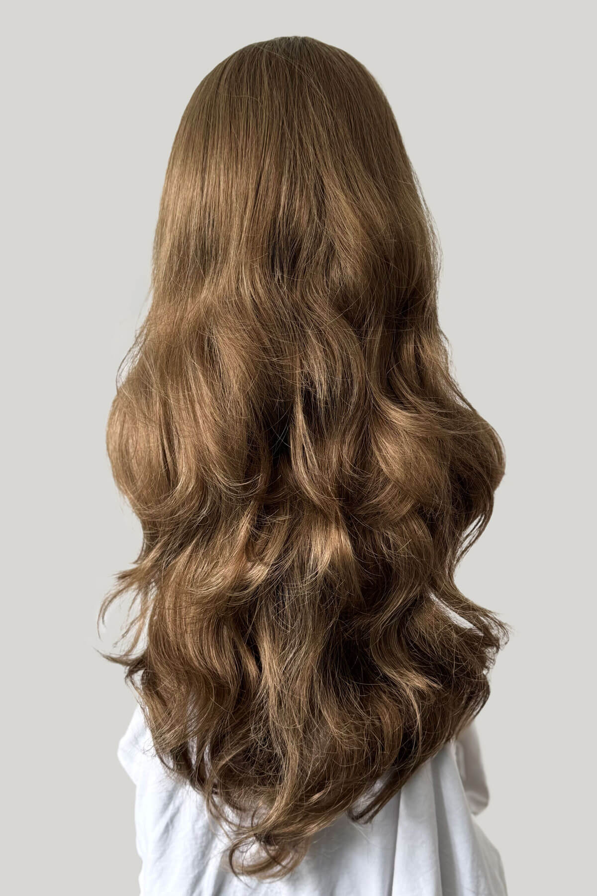 Long, wavy brown hair on a plain background. Light golden brown half wig hairpiece, wavy: Teresa