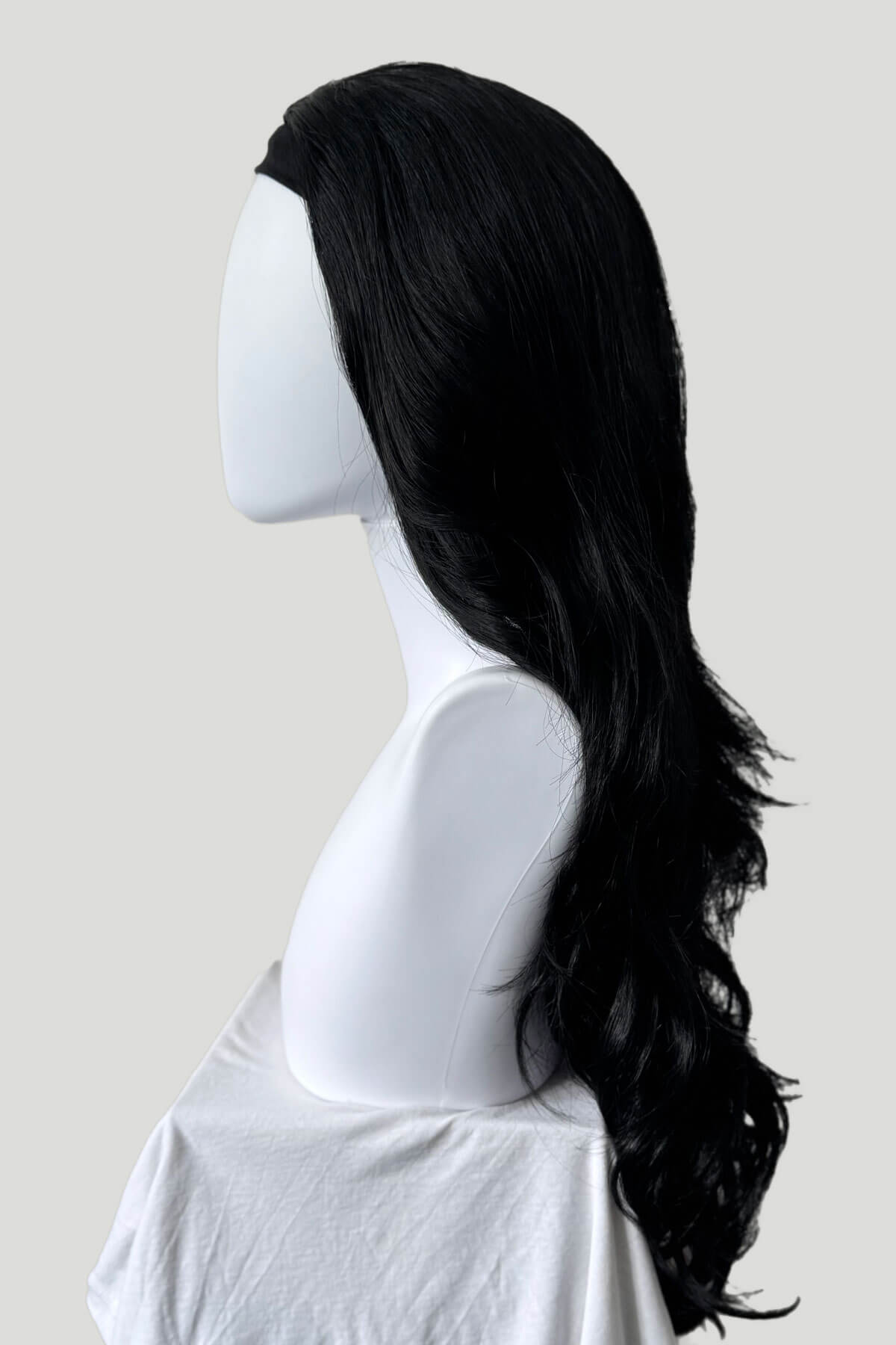 Black wig on a mannequin head against a plain background. Black 3/4 hairpiece (half wig) with long waves: Jessie jet black #1
