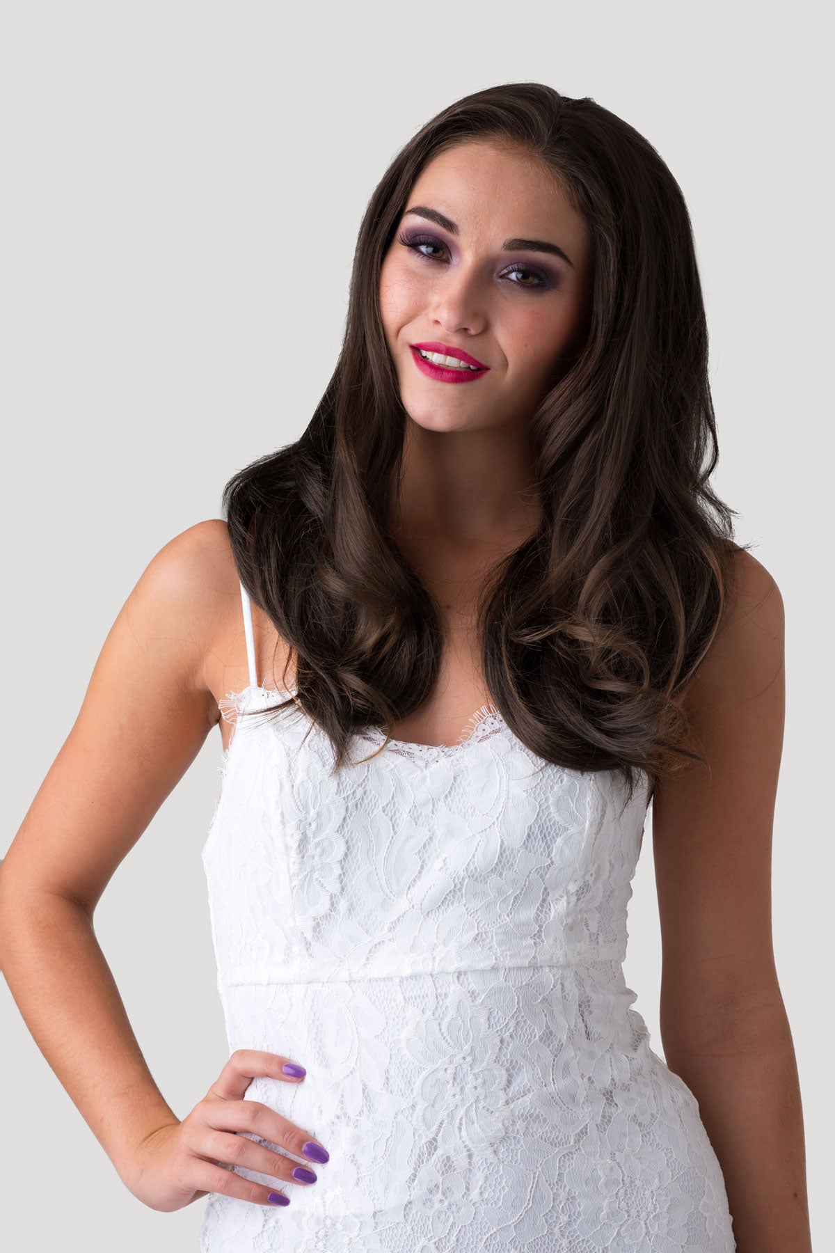 Woman in a white dress with long dark hair against a plain background. Brown half wig hairpiece (3/4 wig), gently layered: Briar chestnut brown 8