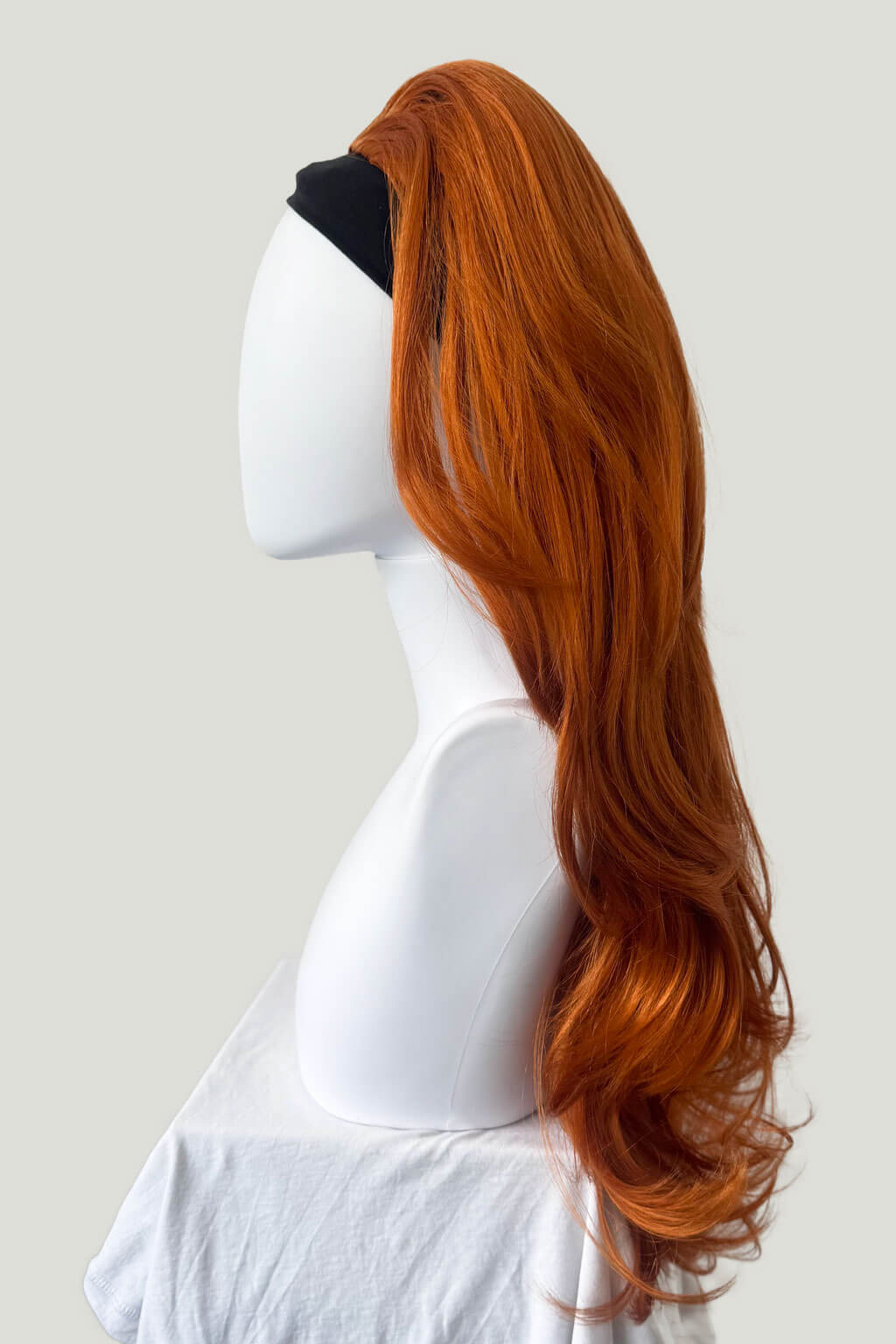Red wig on a mannequin head against a plain background - High crown long, layered half wig and volume ring: Helena ginger