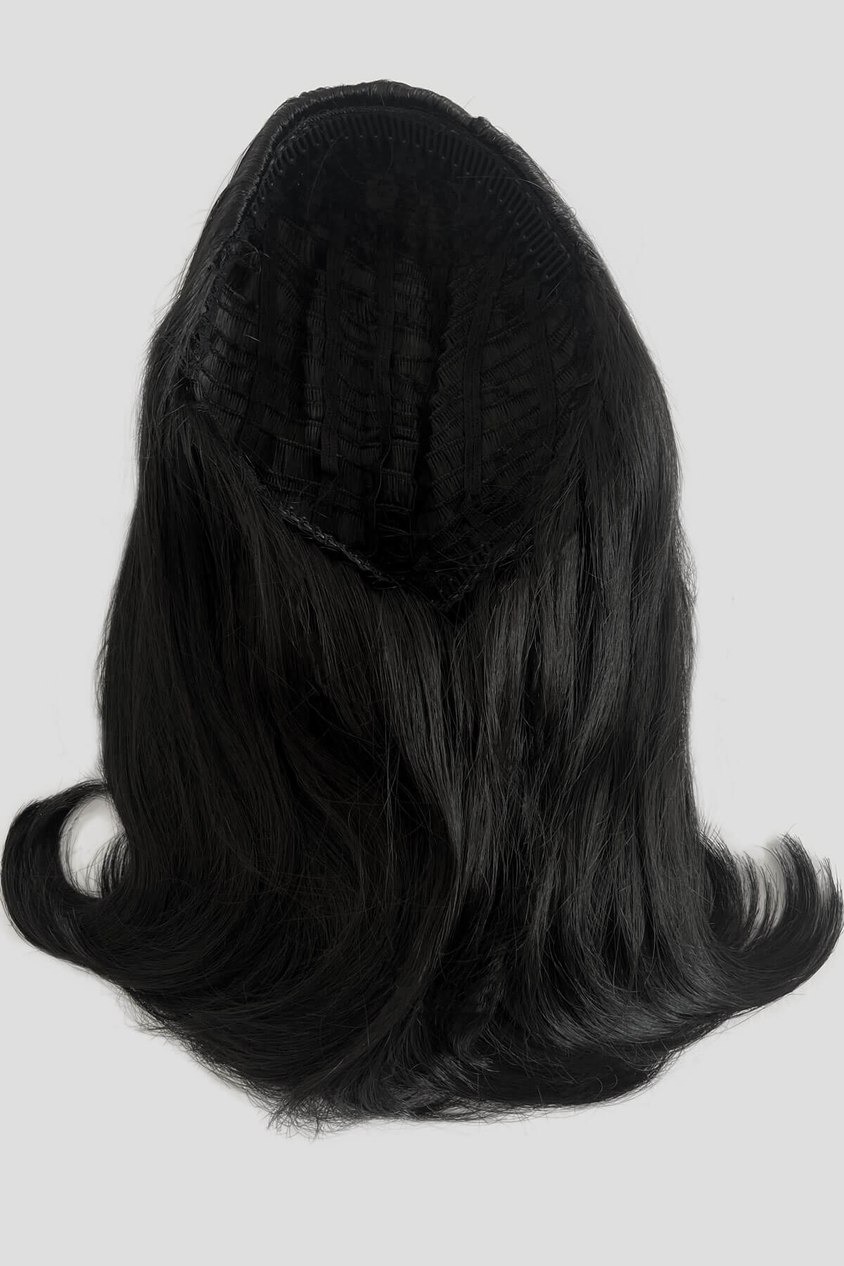 Black wig on a white background. 1960s half wig hairpiece, flicked, hair flip: Philippa black 1B