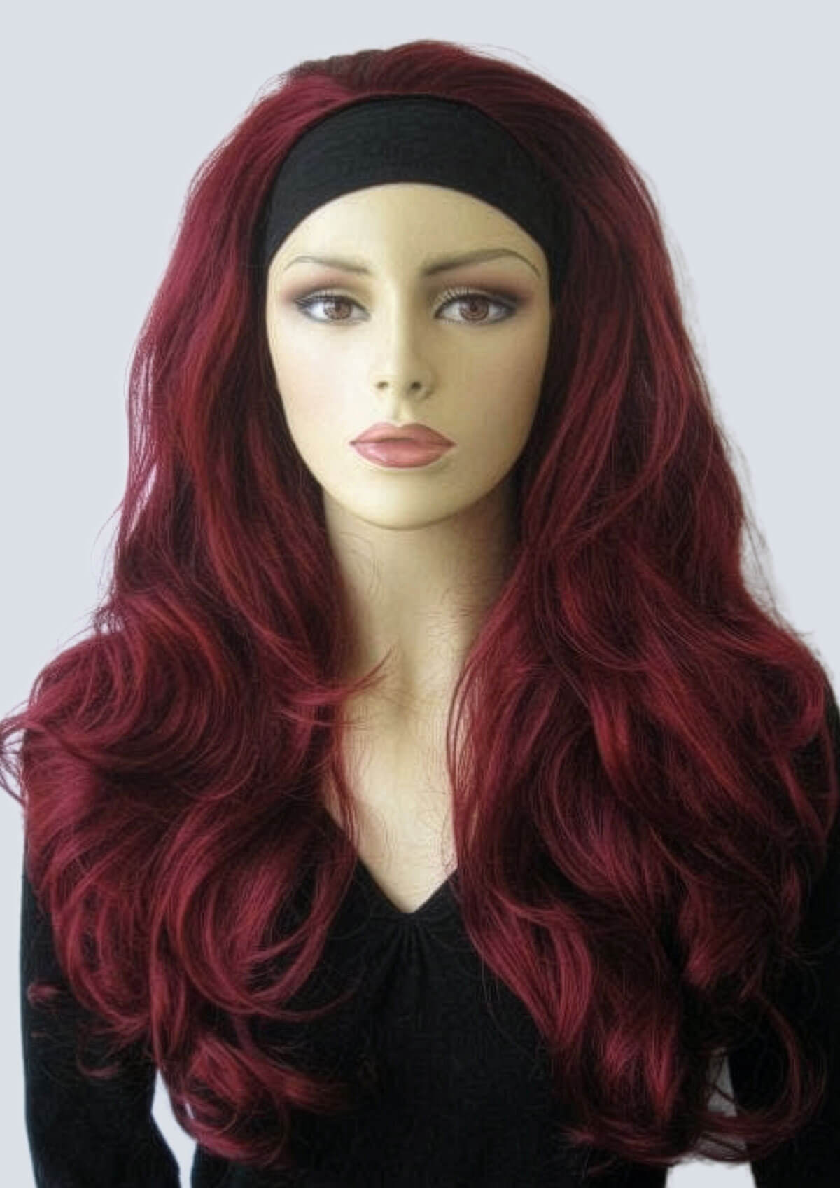 Mannequin head with long red wig and black headband on a white background. Red 3/4 wig hairpiece (half wig), big loose curls: Marie
