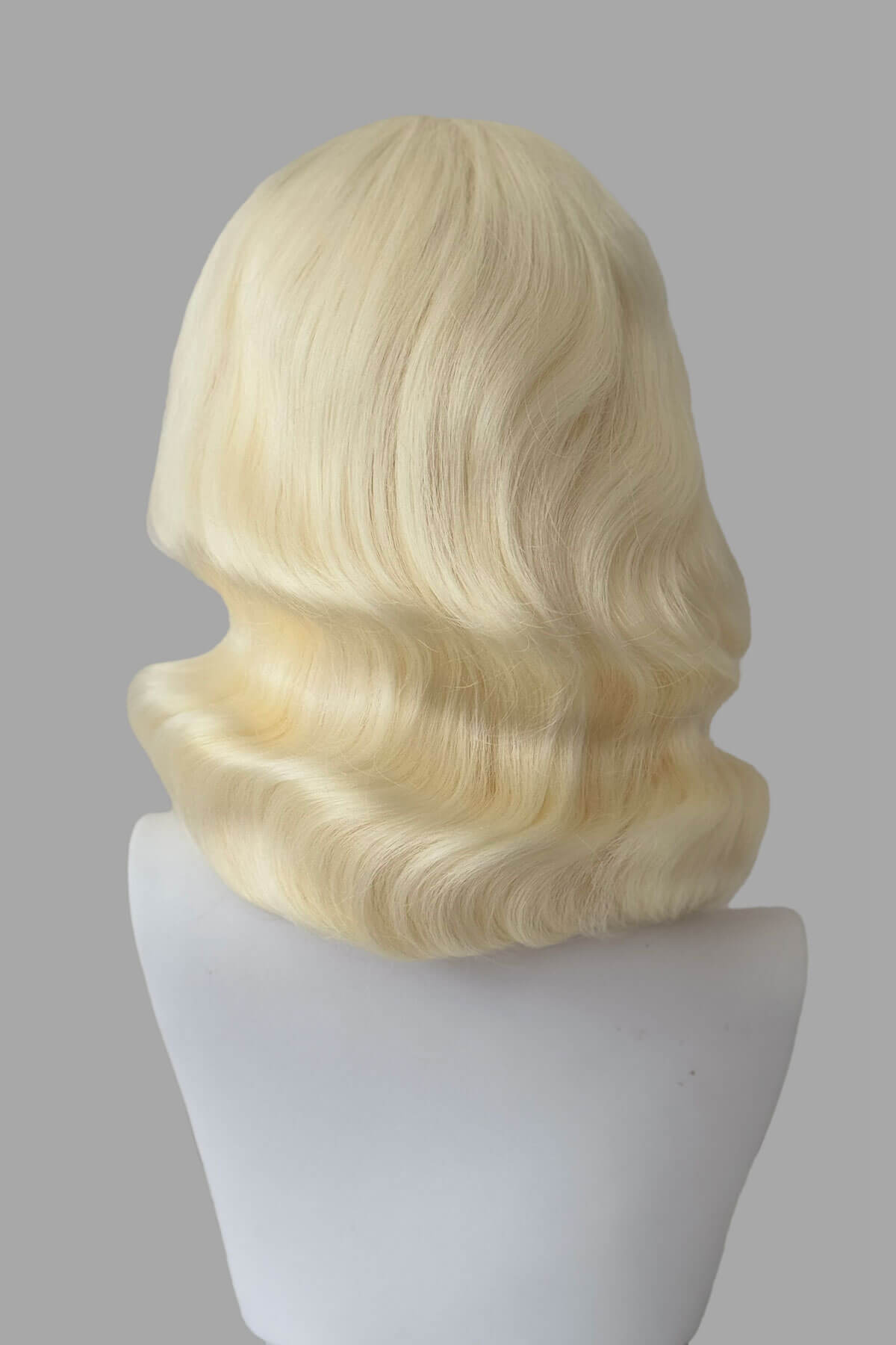 Mannequin with vintage style wig with marcel waves on it, from the back. 1940s style half wig hairpiece with beautiful marcel waves: Virginia platinum 10001