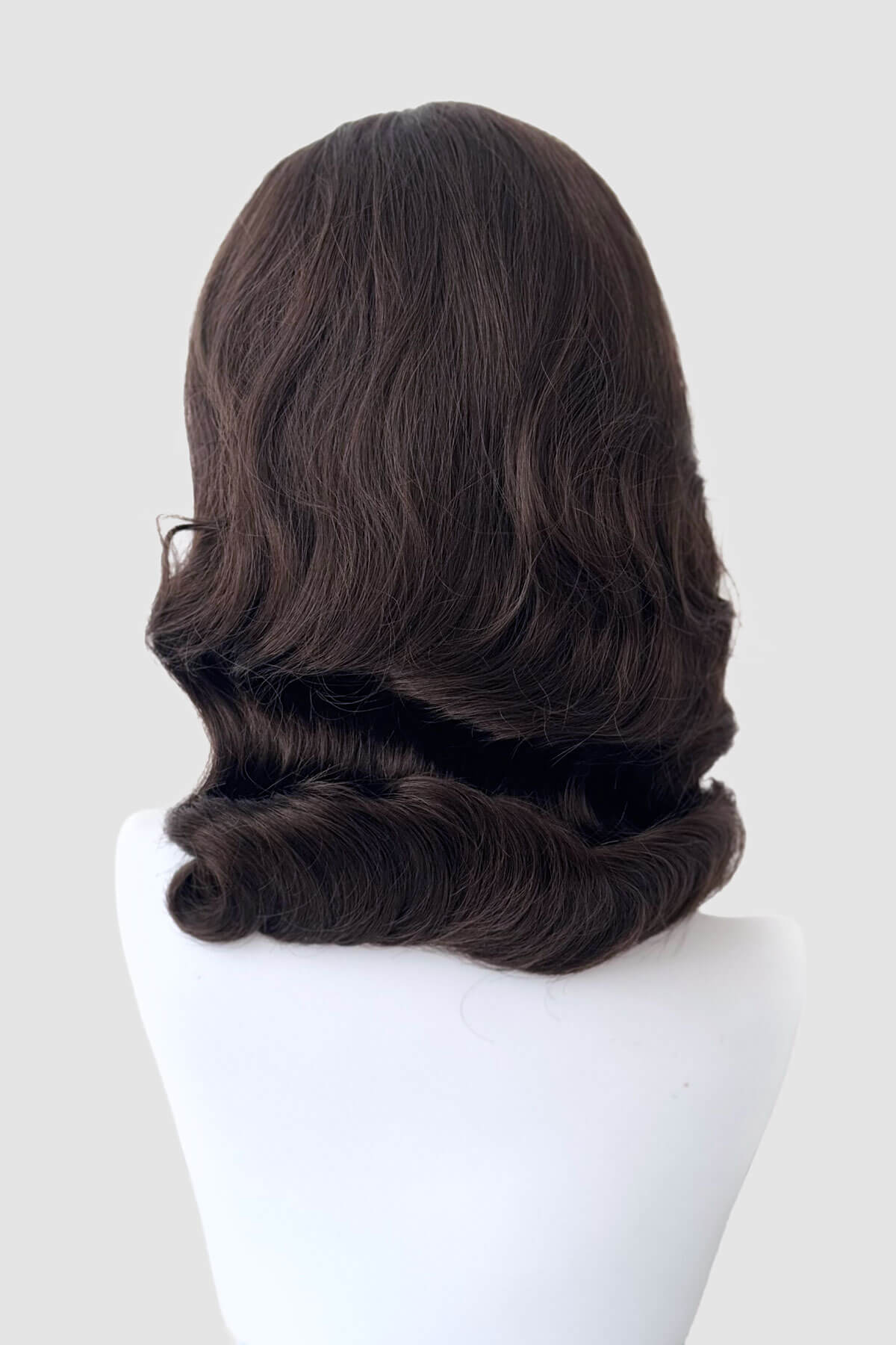 Brown wig on a mannequin head against a white background. 1940s style half wig hairpiece with beautiful marcel waves: Virginia chestnut brown 8