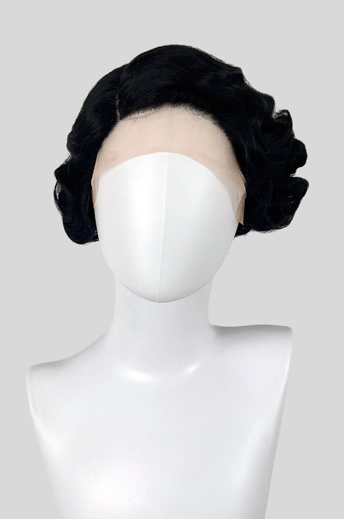 Black hairpiece styled on a mannequin head against a white background. Black lacefront wig, pinup/vintage style, short with finger waves: Viola