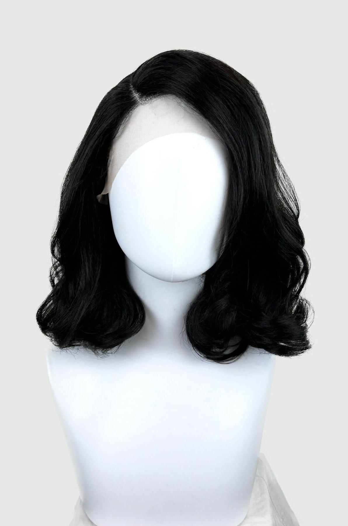 Black lacefront wig with side partingon a mannequin. Black shoulder length long bob (lob) lacefront wig with side sweeping fringe/bangs: Amaris