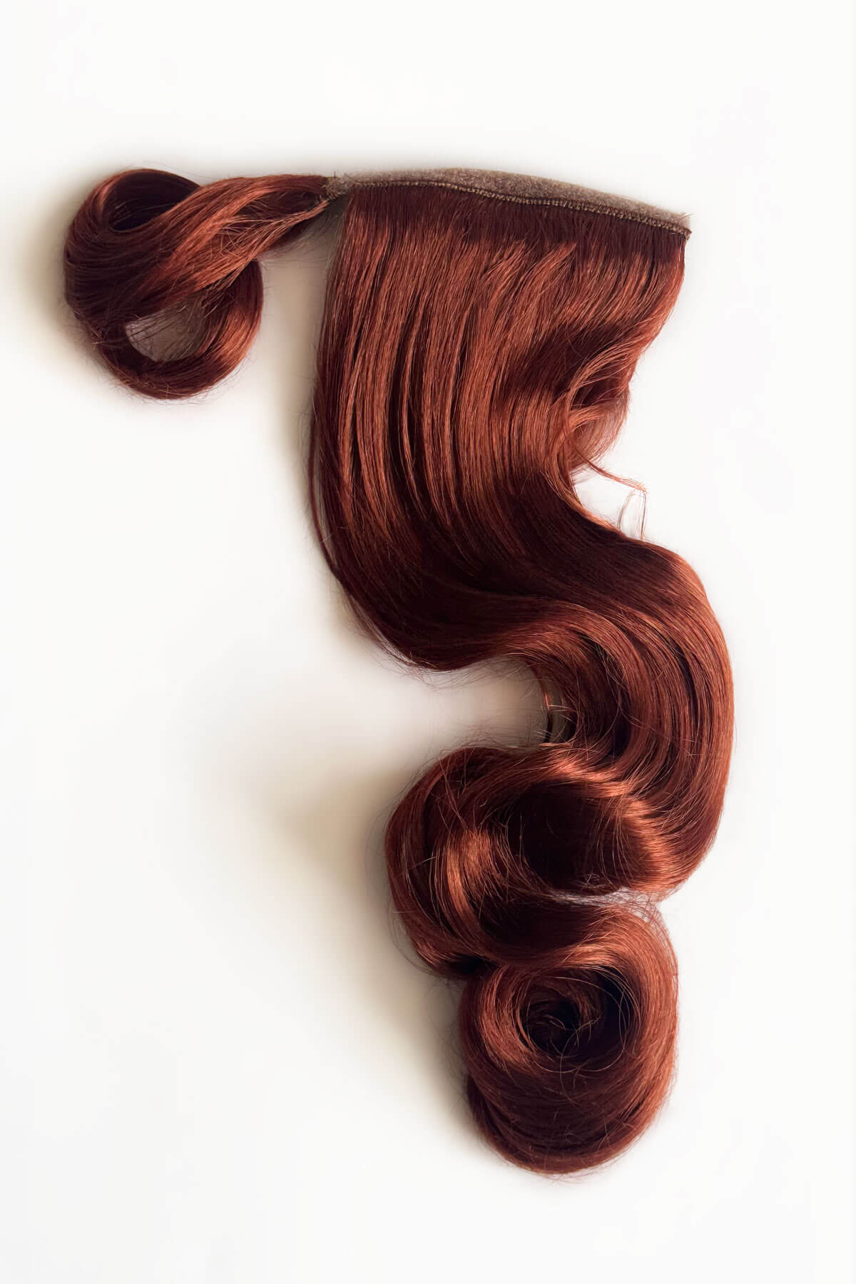 Copper red hair extension on a white background. Long ponytail hairpiece with vintage waves: Kitrysha -copper 130