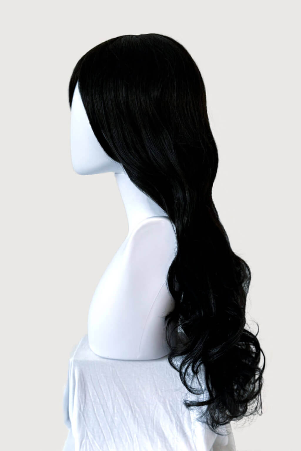Black wig on a mannequin head against a plain background. Long wavy black wig with side-sweeping Fringe: Charlotte