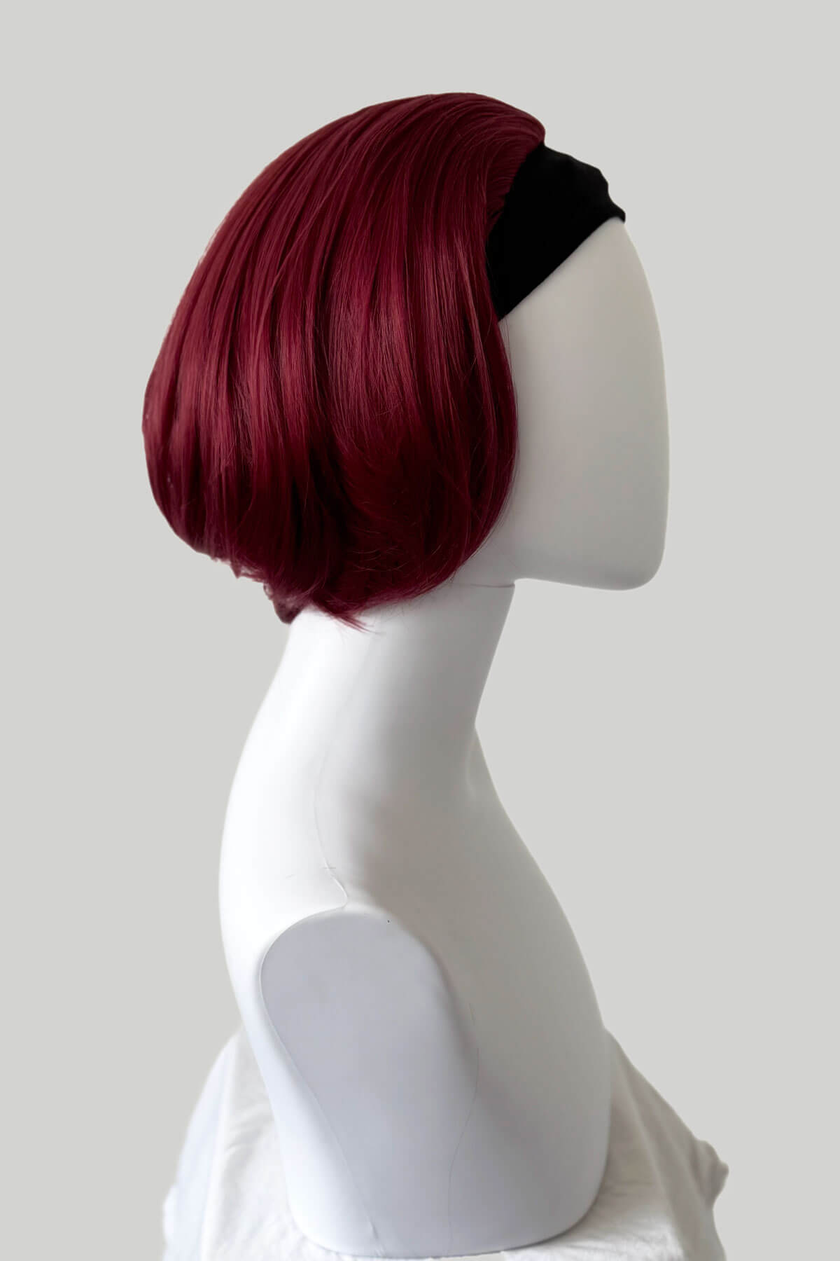Red wig on a mannequin head against a white background. Bob half wig hairpiece, Flexihair: Amelie wine red 39