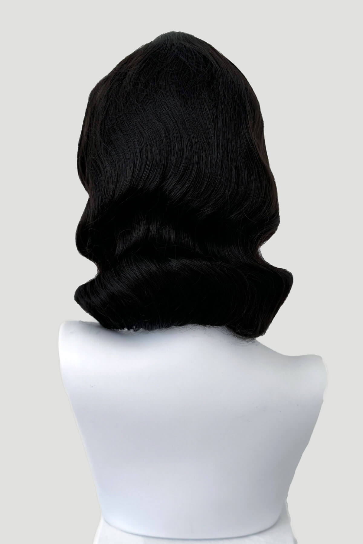 Black wig on a white mannequin head against a light gray background. Brown 1940s pinup style wig, with finger waves: Honey dark brown 4