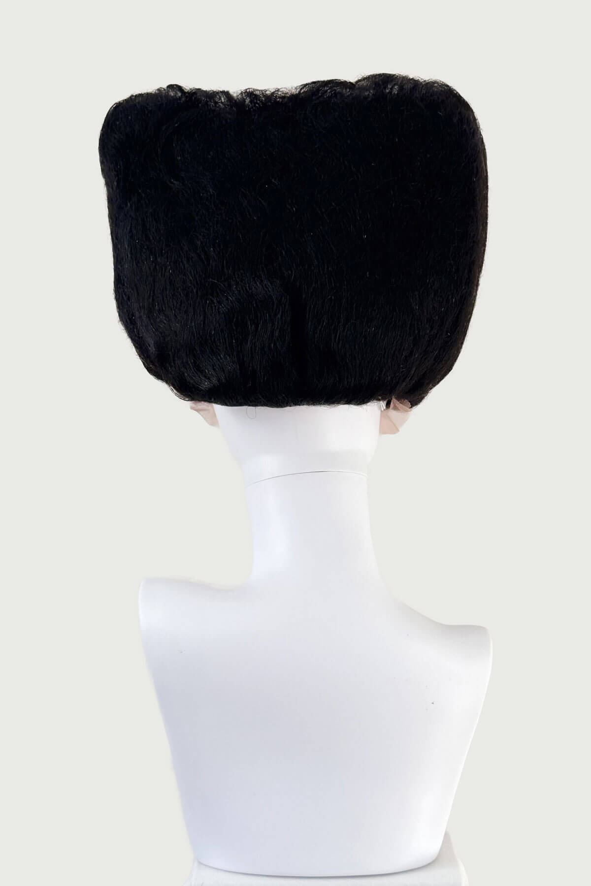Black wig on a mannequin head against a white background. Black wig with white fringe on a mannequin head against a white background. Bride of Frankenstein lacefront wig, black with platinum streaks: Eva