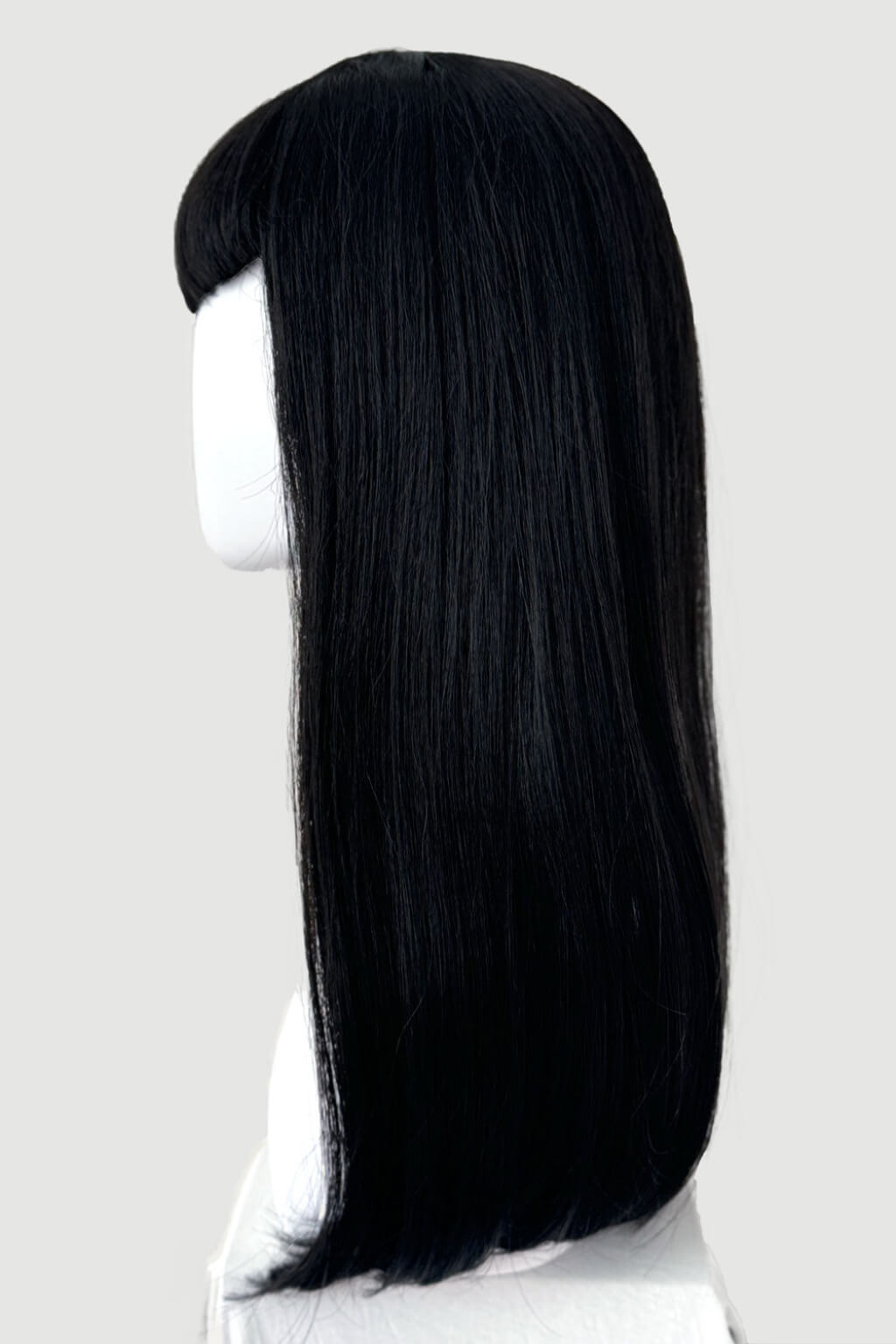 A long, straight black wig with a straight bang, displayed on a white mannequin head and neck against a light grey background. Long black wig with straight hair and a short, straight fringe: Maxine