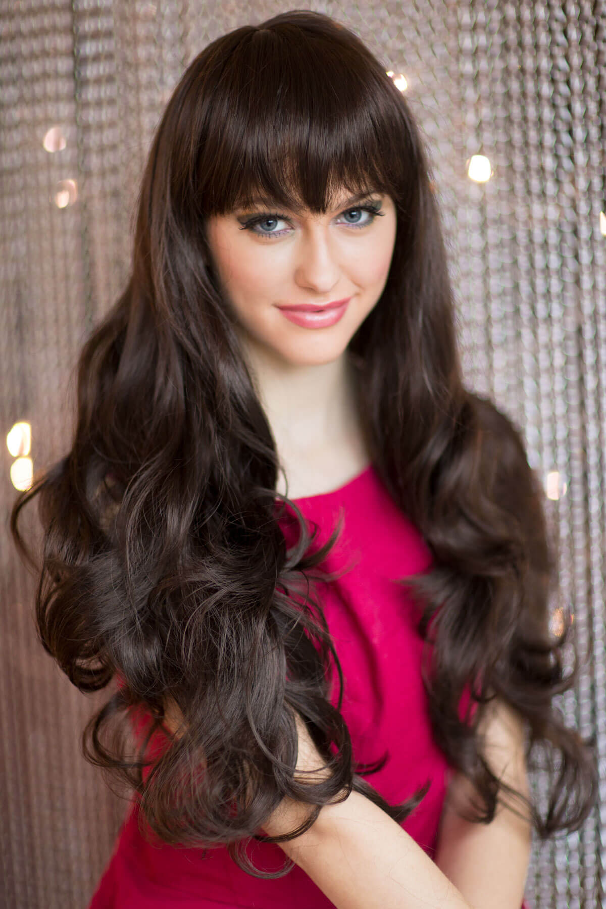 Mannequin head with long dark hair and a red top against a textured wall. Long dark brown wig with gentle waves: Marina