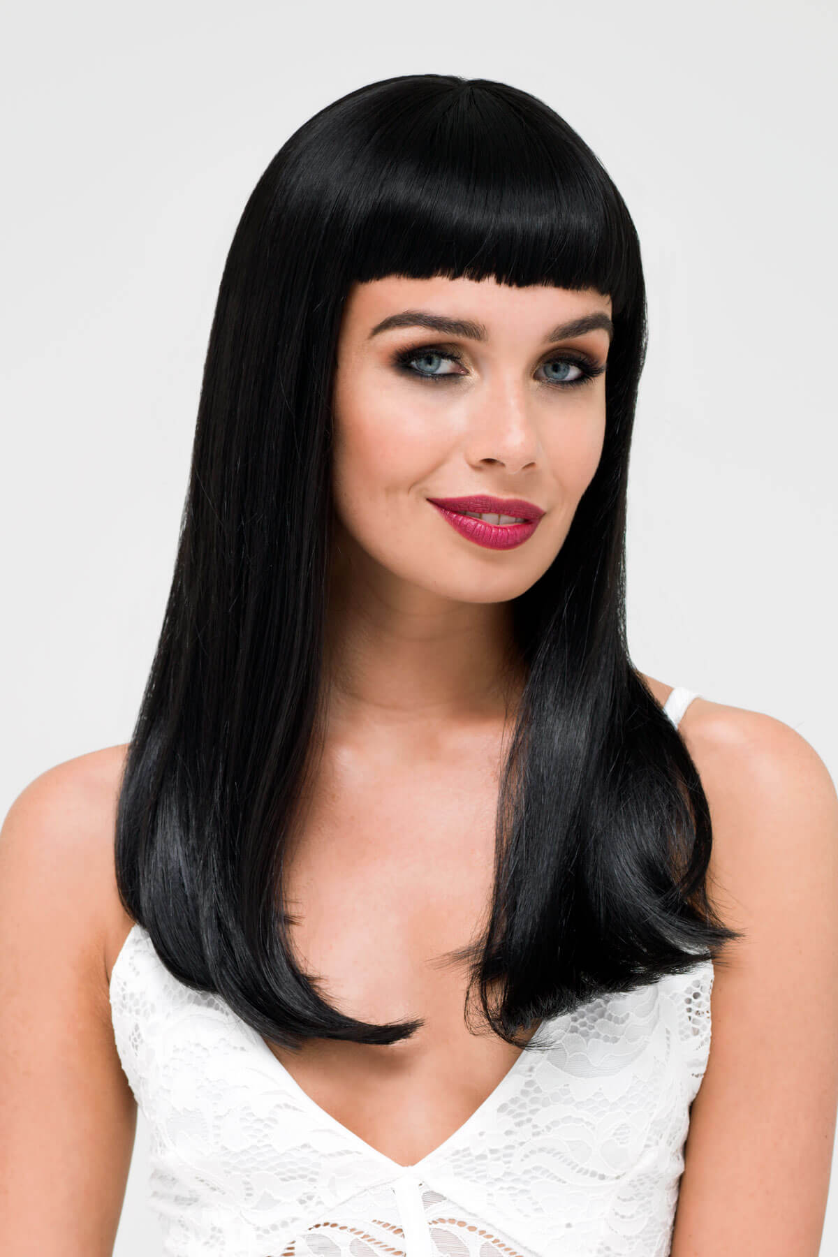 Woman with long black straight hair and bangs against a white background. Long black wig with straight hair and a short, straight fringe: Maxine