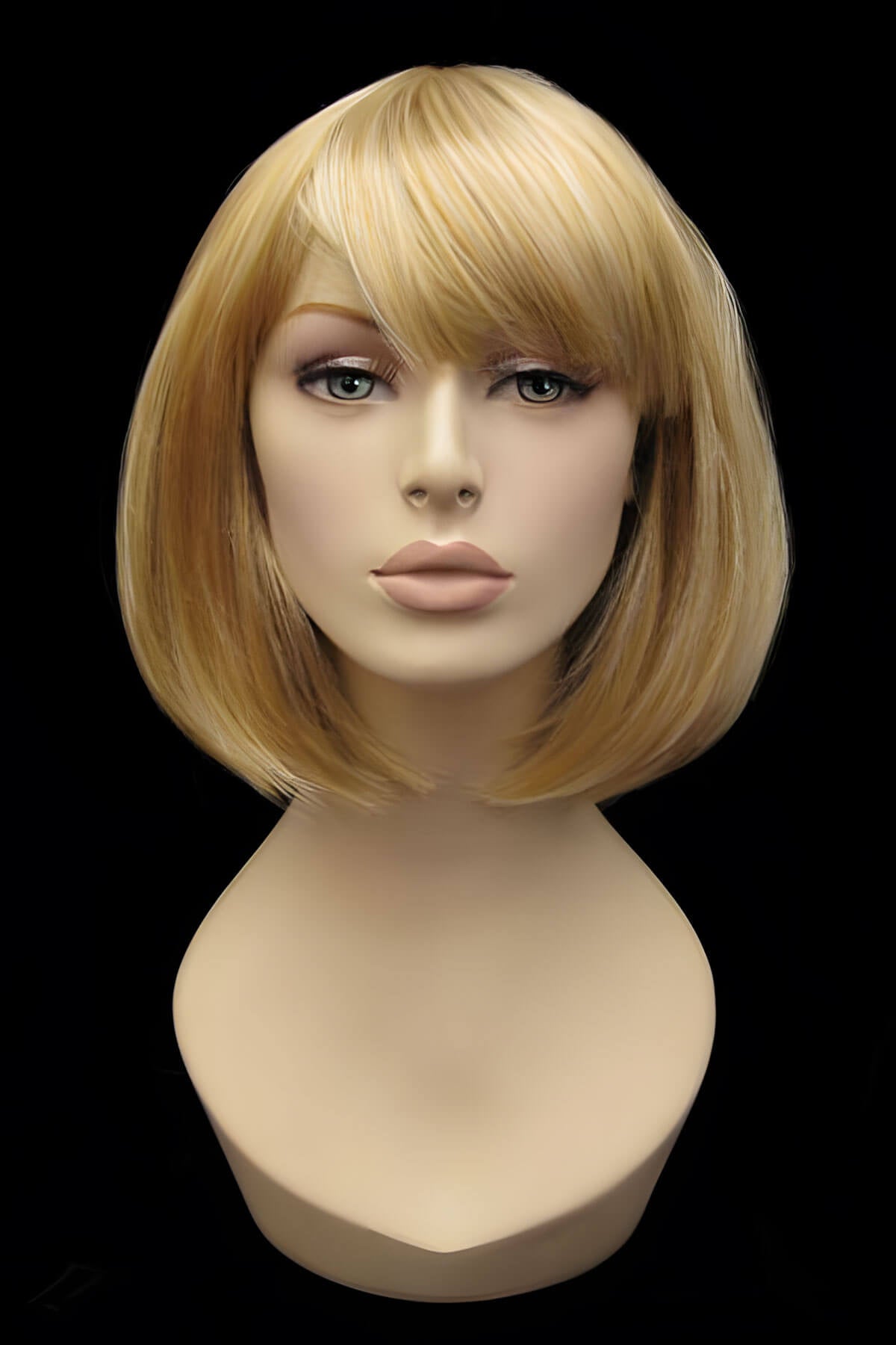 Blonde wig on a mannequin head against a black background. Blonde inverted bob wig: Rhiannon honey blonde 24BH613