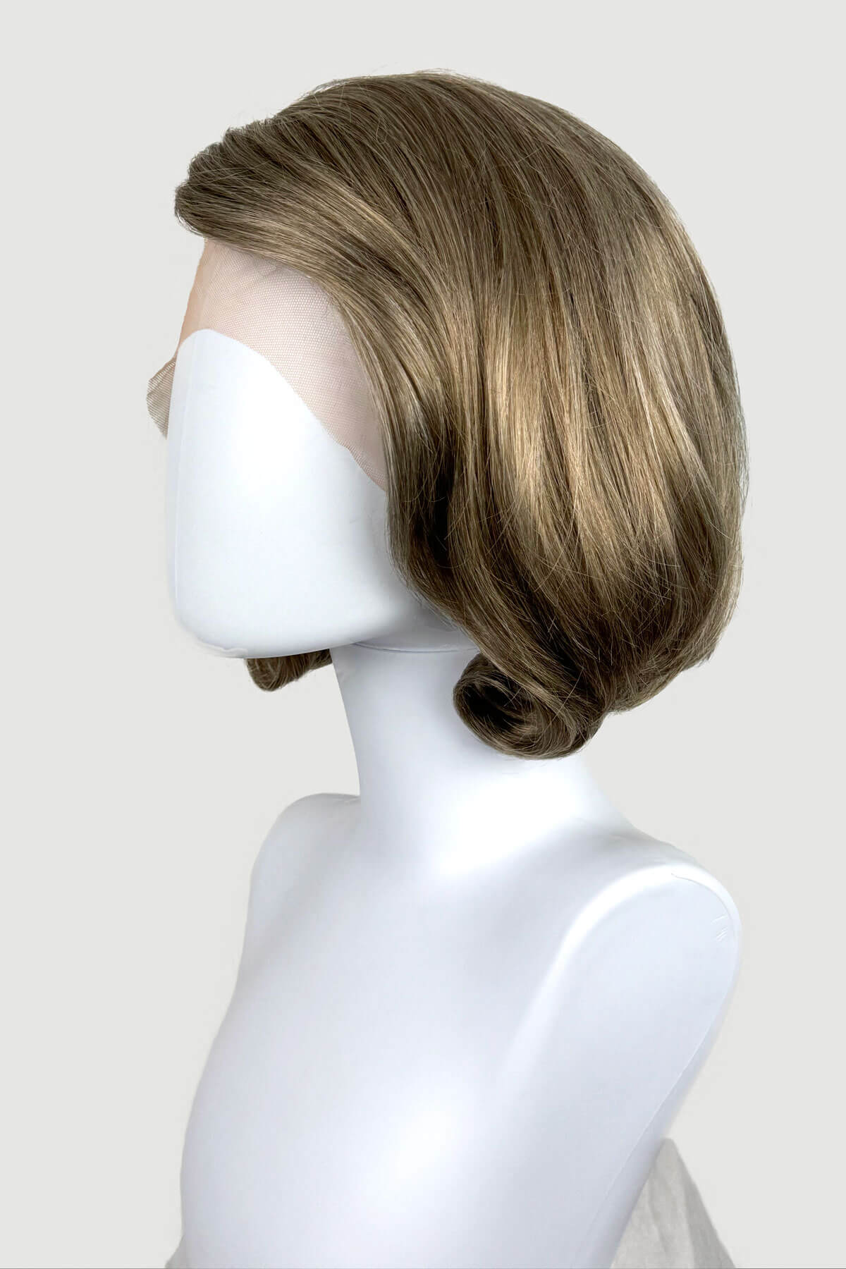 Mannequin head with a brown wig on a white background. Dark golden wig, lace front, rockabilly style with victory rolls: Bobbie