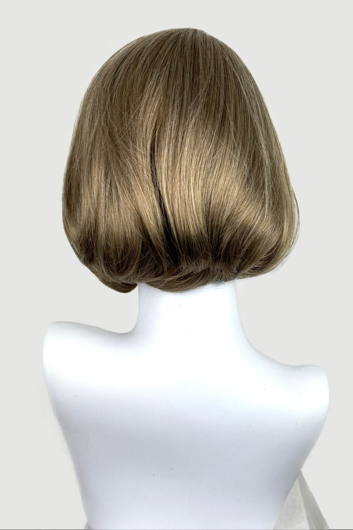 Blonde wig on a mannequin head against a white background. Dark golden wig, lace front, rockabilly style with victory rolls: Bobbie