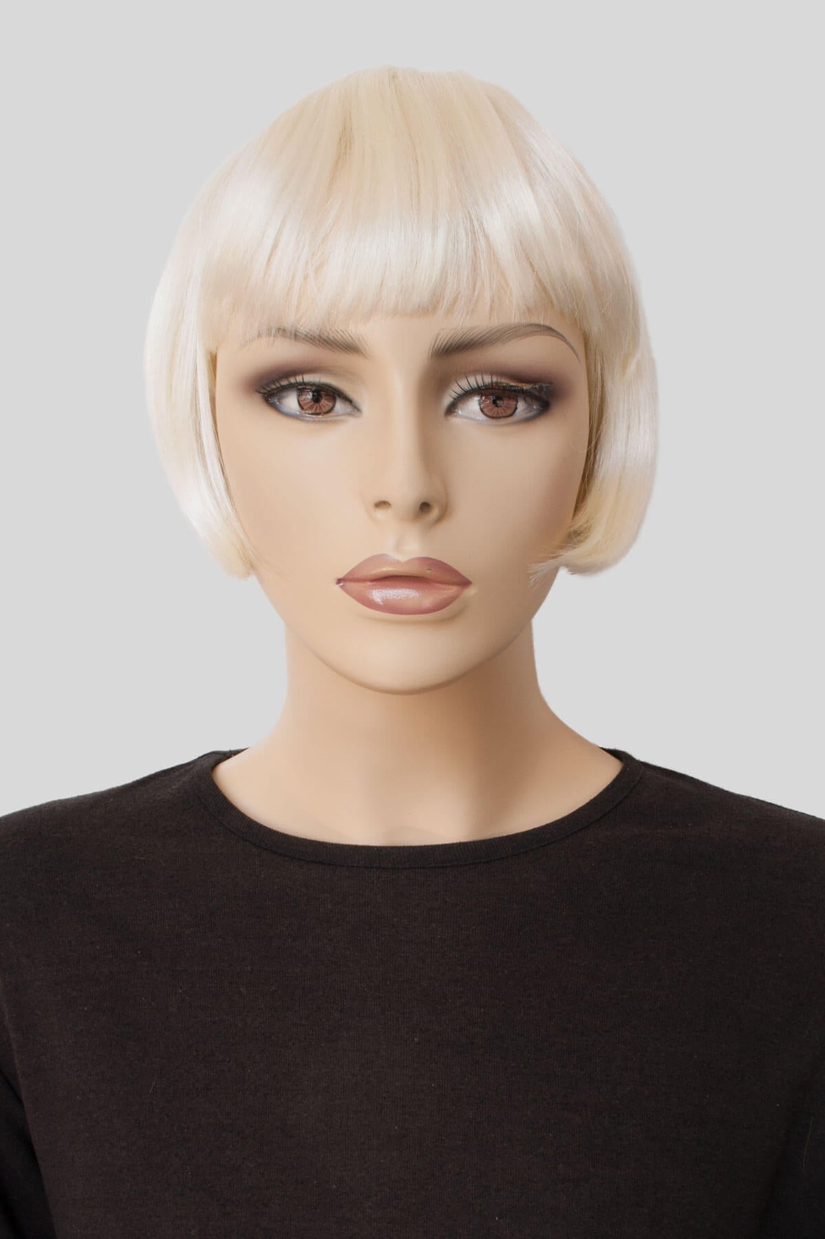 Mannequin head with a blonde wig on a plain background. Blonde 1920s bob wig, short, Louise Brooks style: Agyness