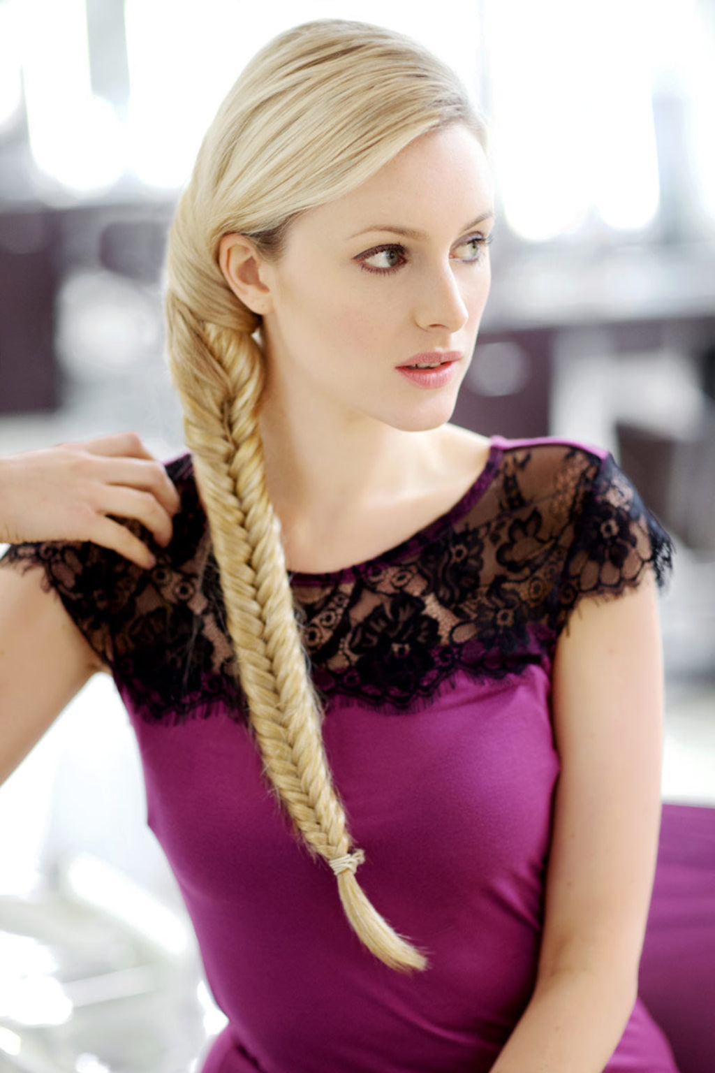 A woman wearing a white top showcasing a fishtail plait hairpiece extension. Fishtail plait (braid) hairpiece extension: Tinsley