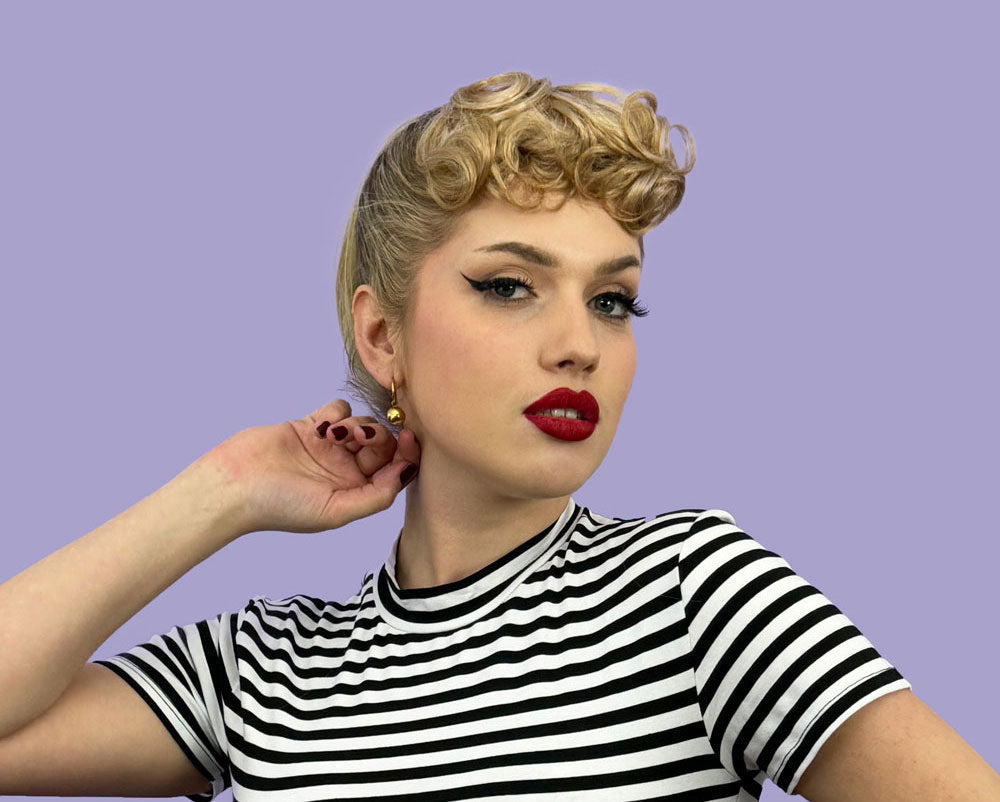 Why curly bangs keep returning — from 1940s glamour to Barbie