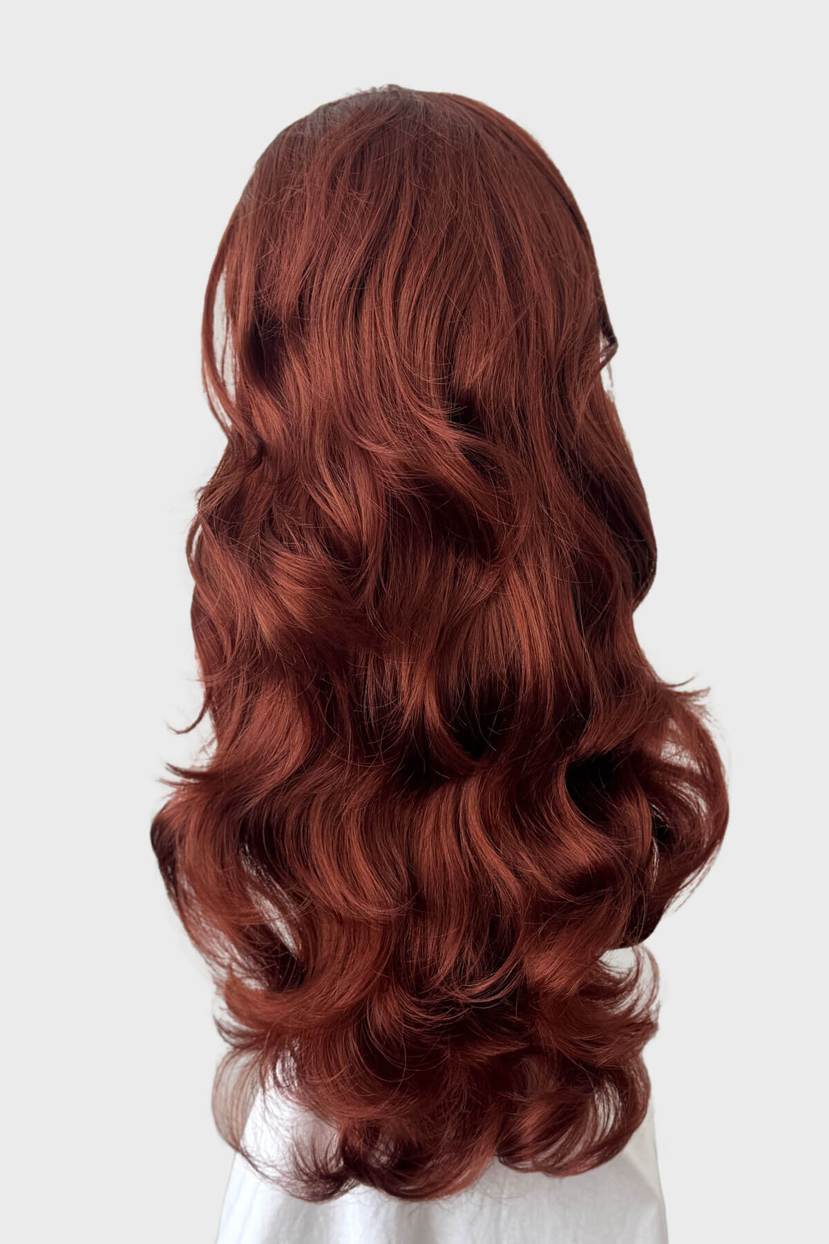 Copper red wig on a mannequin head against a white background. Verity - Super Full Volume, Extra Long Loose Curls Red Half Wig