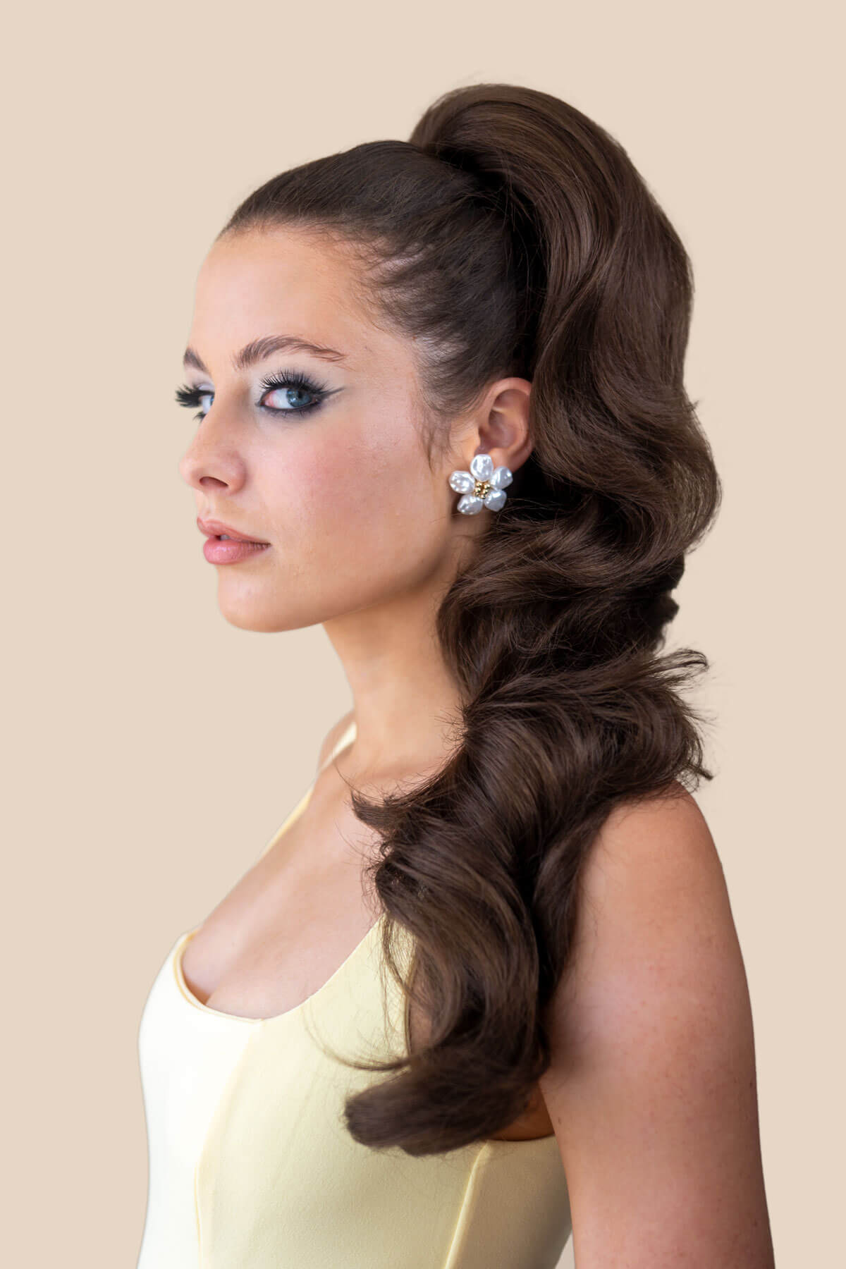 A woman wearing a purple dress and a double volume hairpiece extension with gentle waves. Chestnut Brown 8