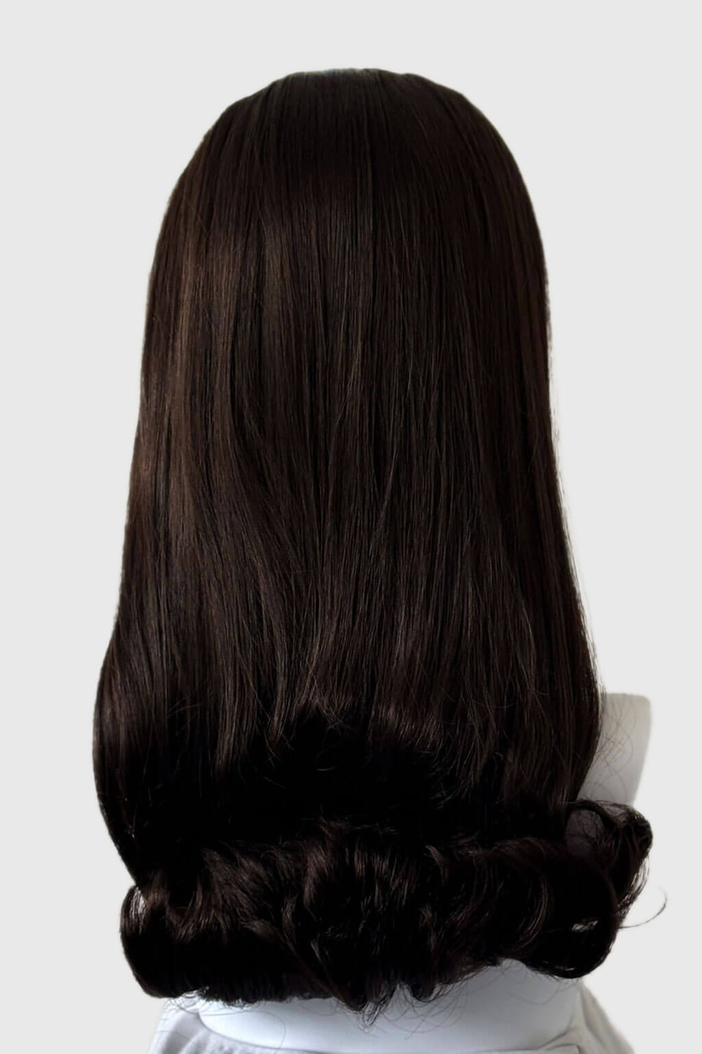 Dark brown wig on a mannequin head against a white background. 1960s Retro high crown, half wig hairpiece, long with hair flip: Priscilla chocolate brown 6