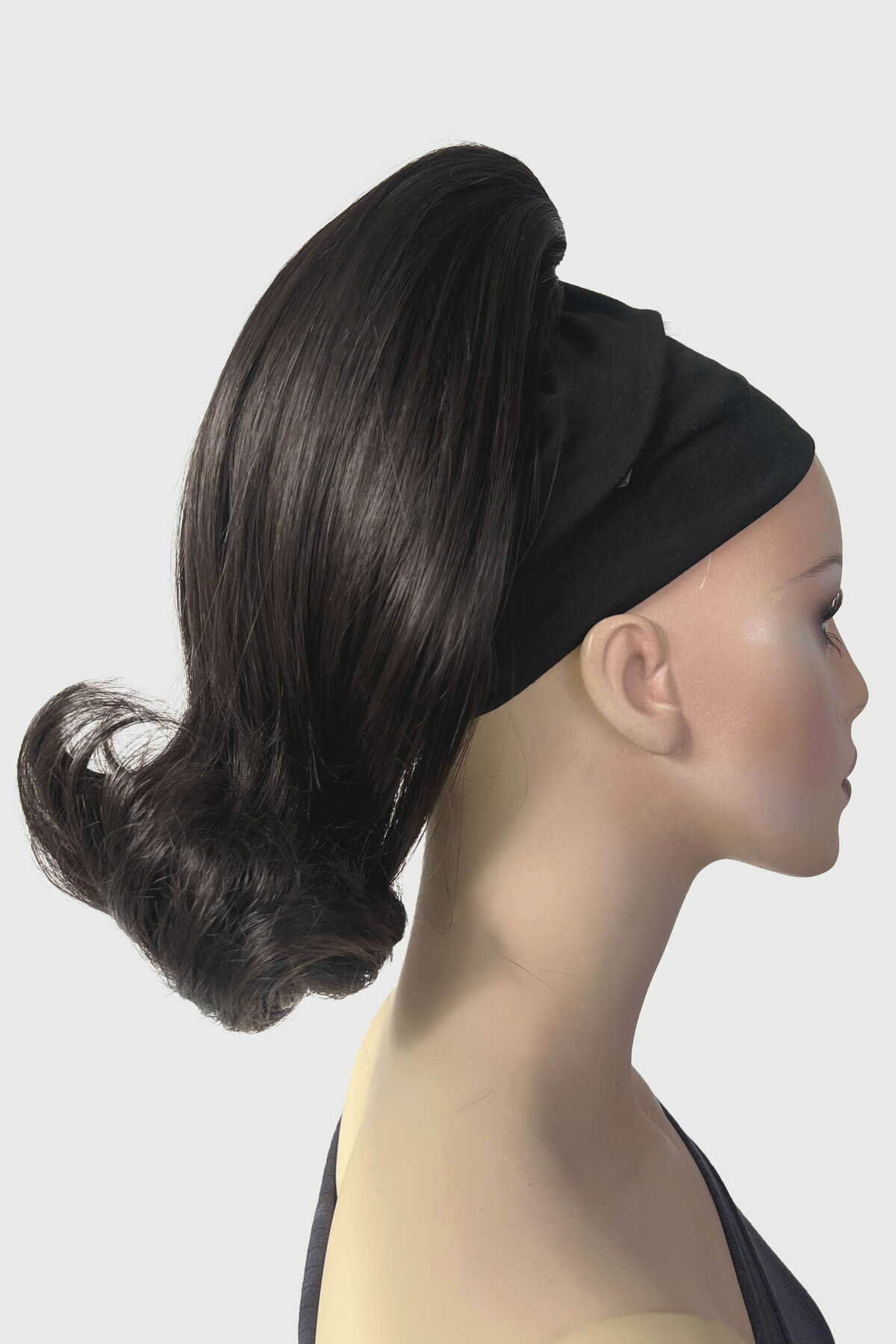 Mannequin head with black hair bun and headband on a white background. Ponytail hairpiece, shoulder length with flick/flip, retro 1960s style: Ariana dark brown 4