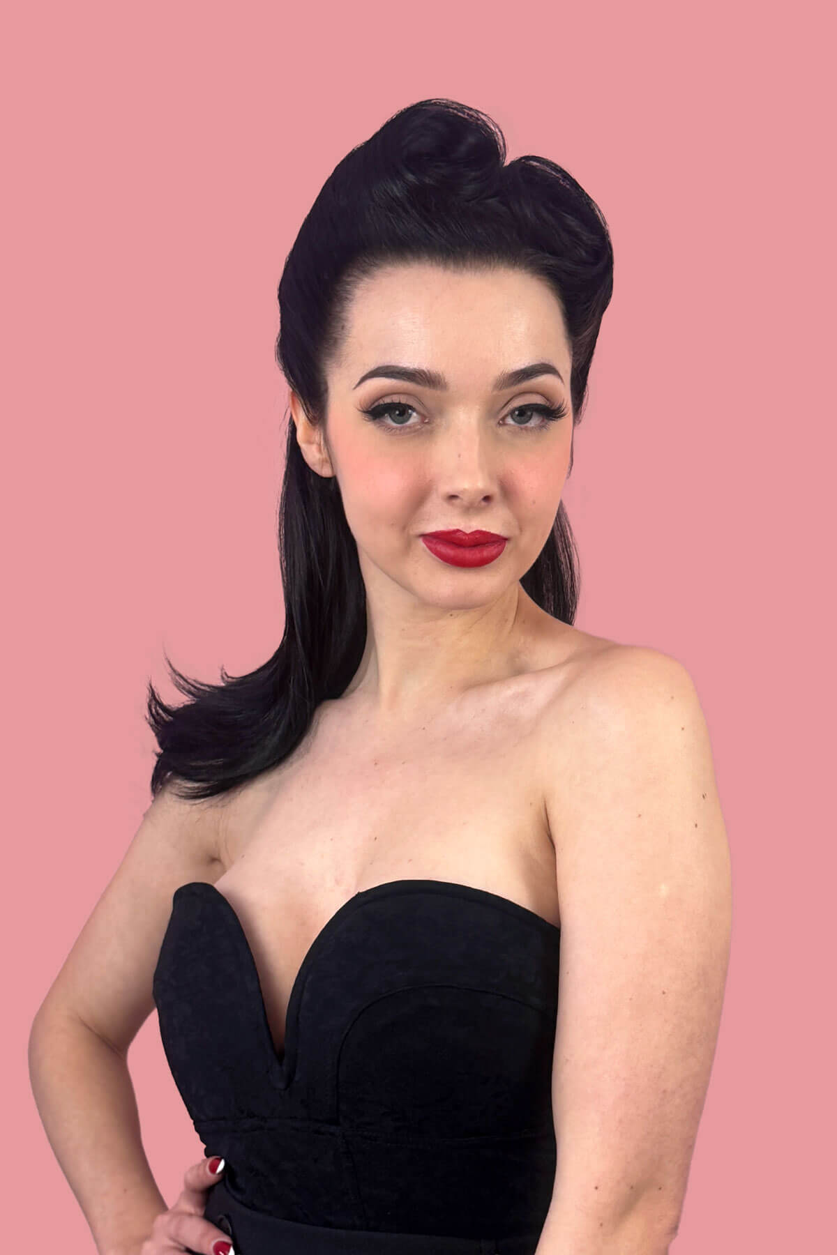 Woman with a long, black, high ponytail against a pink background. Long ponytail hairpiece, straight with flick: Clarisa black 1B