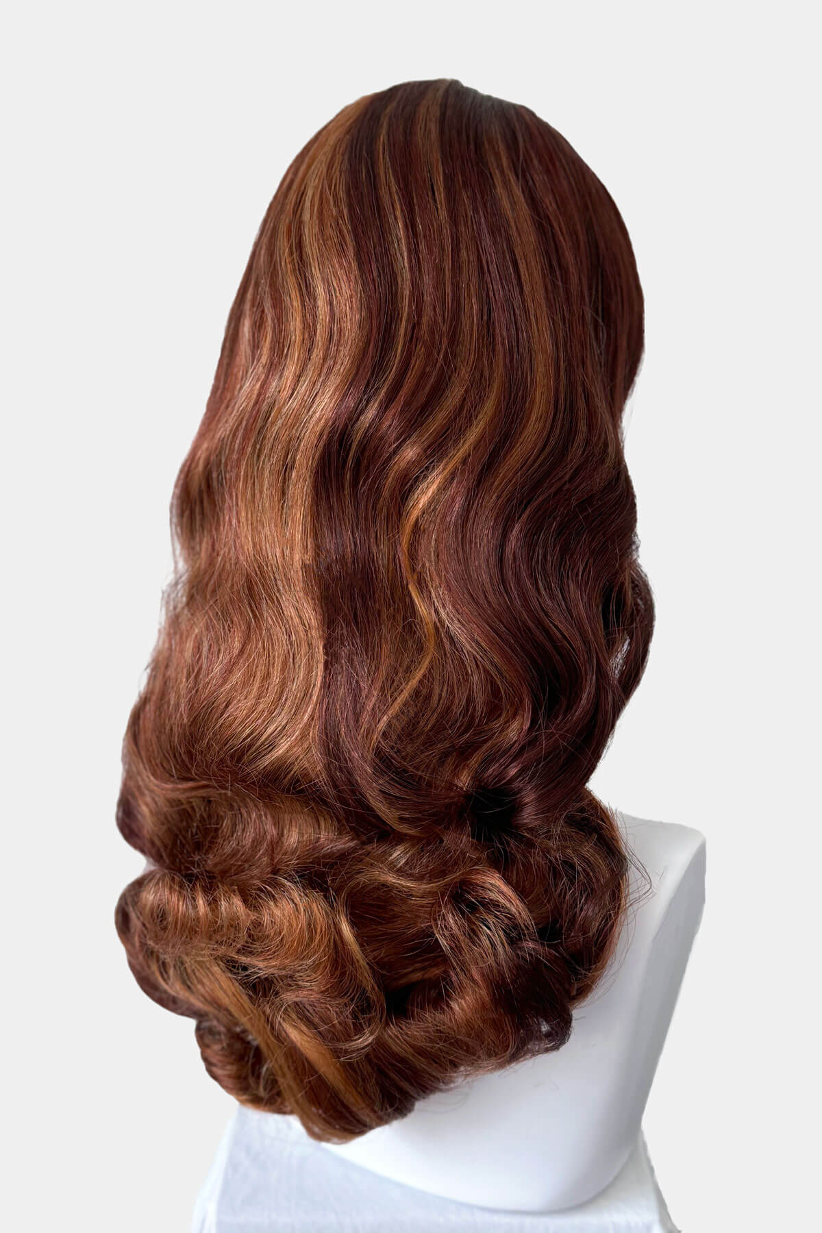 Auburn and blonde wig on a mannequin head against a white background. 1950s style half wig hairpiece with beautiful waves: Morgana auburn BO
