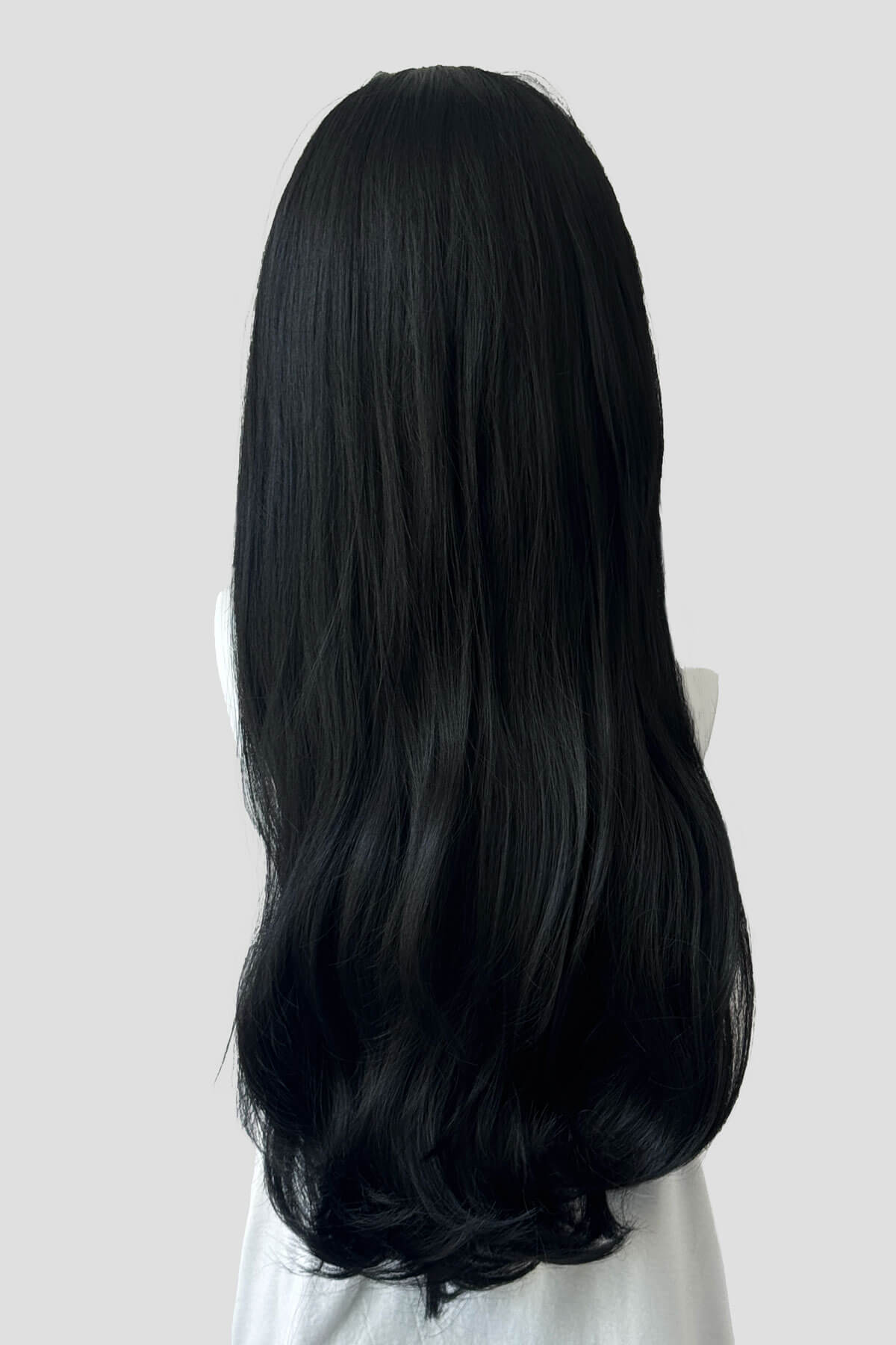Long, black wig on a plain background. Kate - Heat Styleable Extra Long, Gentle Wave Half Wig black 1B