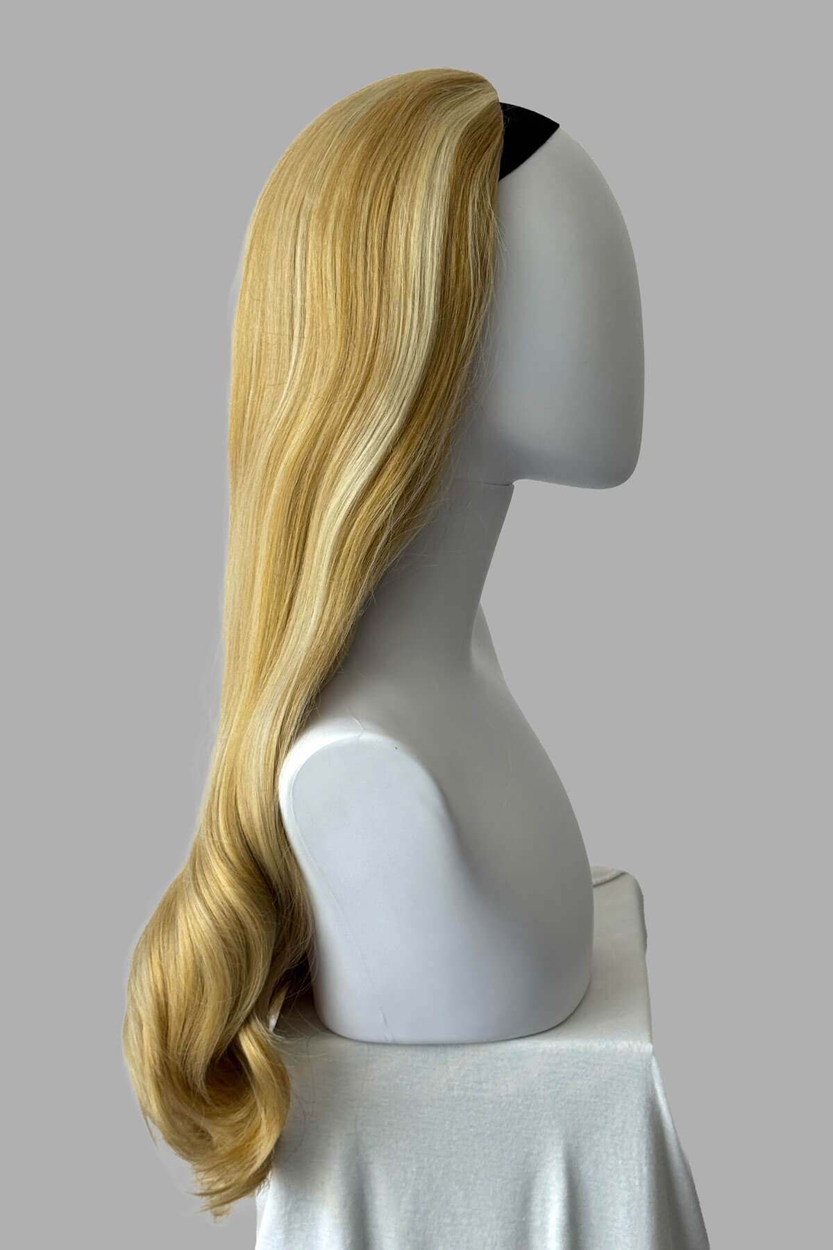 Mannequin head with warm blonde wig on a plain background. Kate - Heat Styleable Extra Long, Gentle Wave Half Wig  blonde 24BH613