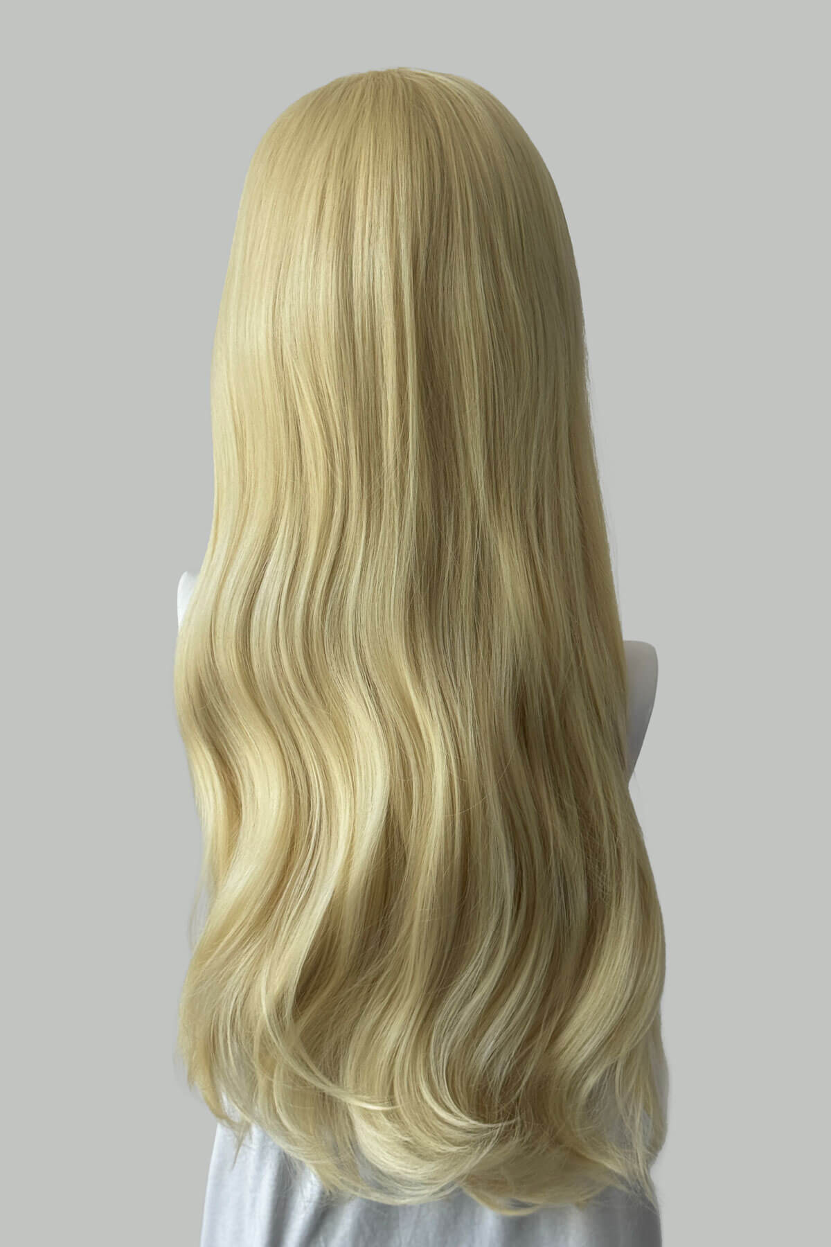 Blonde wig on a mannequin head against a plain background. Kate - Heat Styleable Extra Long, Gentle Wave Half Wig  blonde 613
