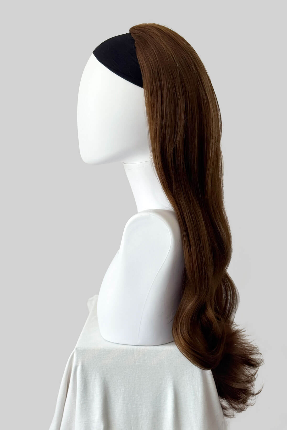 Long, light brown wig on a plain background. Kate - Heat Styleable Extra Long, Gentle Wave Half Wig  dark light brown 12